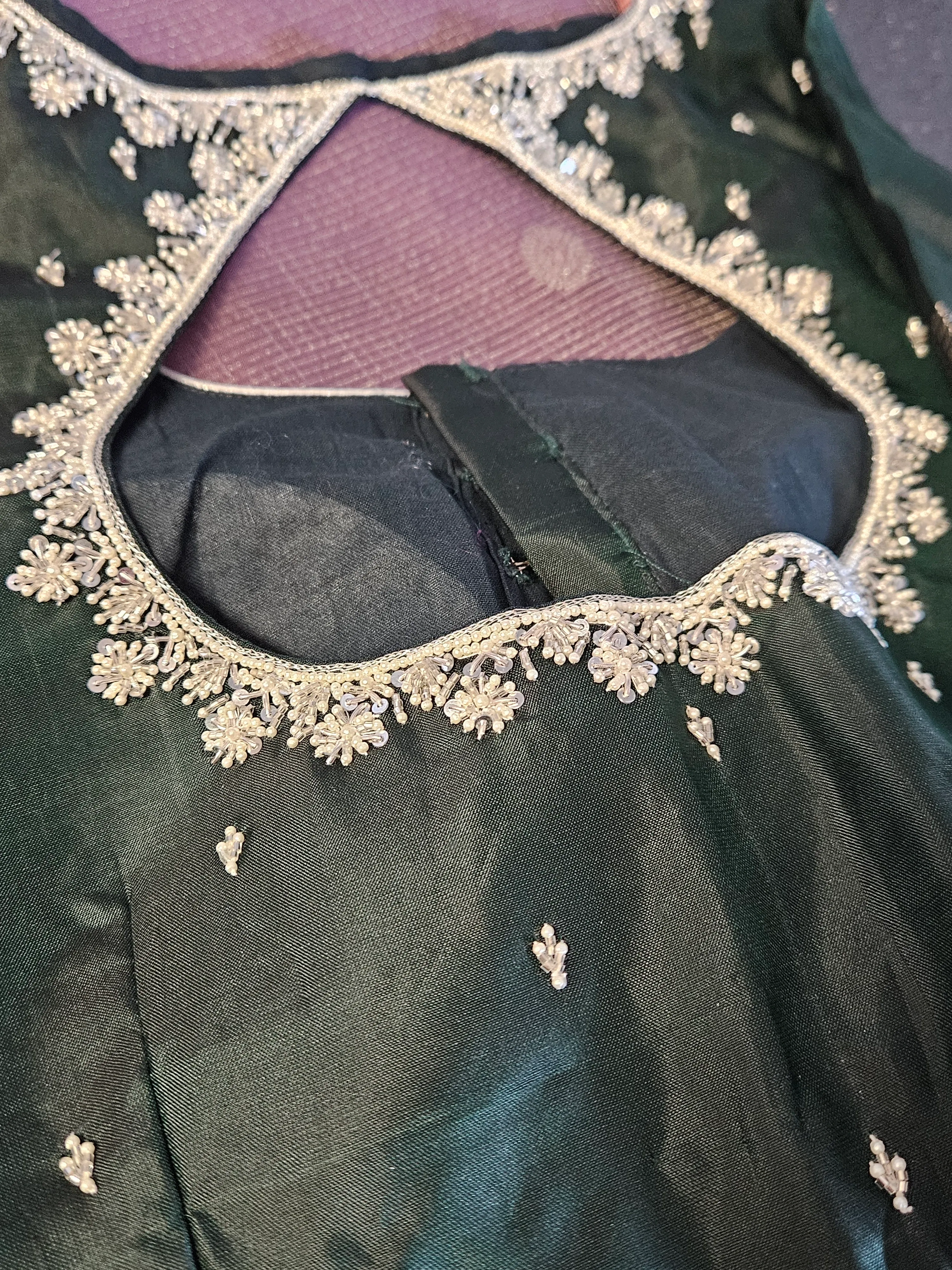 Handcrafted pure Kanchipuram silk saree in deep green with multicolor zari floral motifs and intricate gold embroidery.
