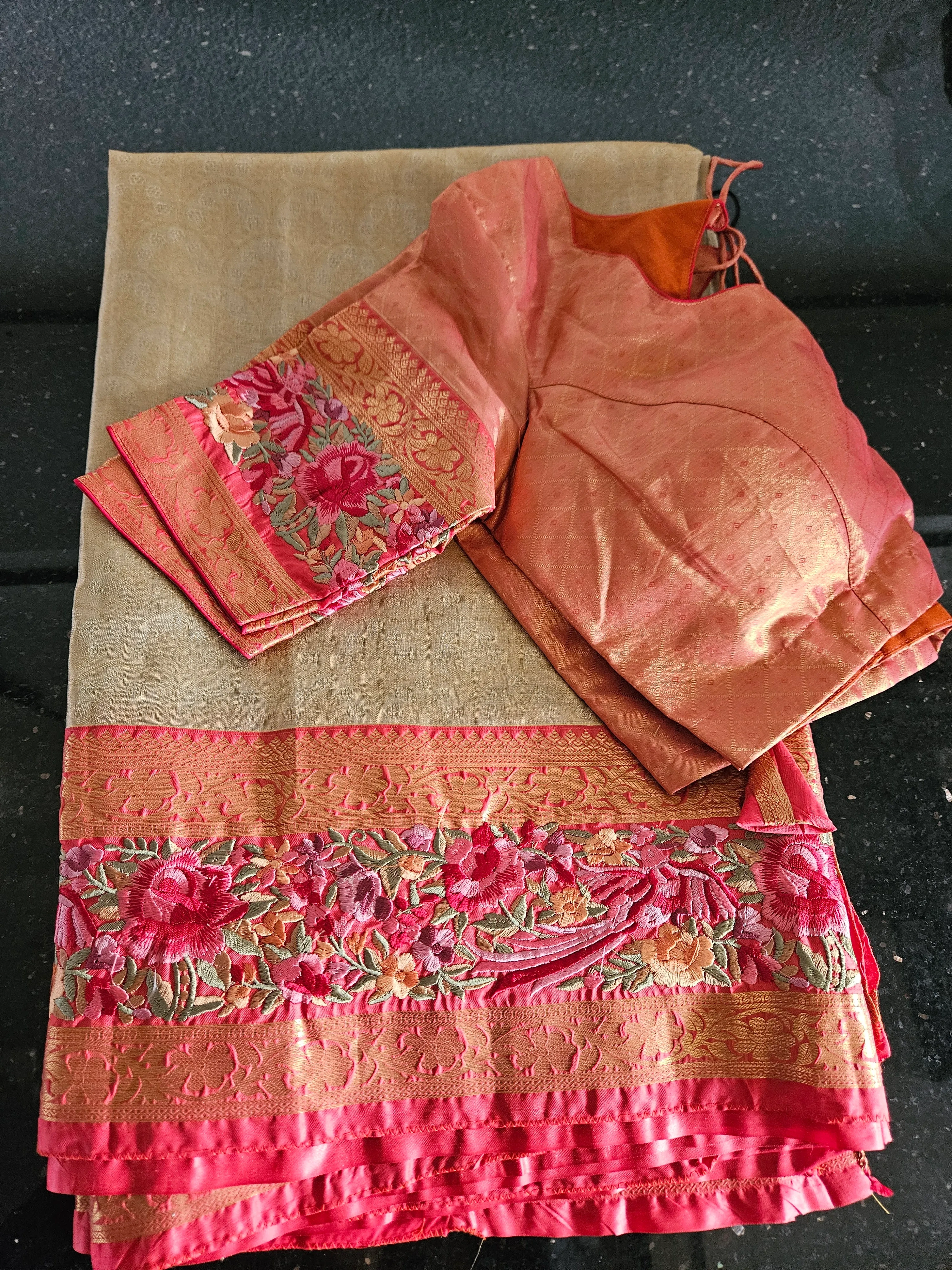 Handwoven pure Kanchipuram silk saree in beige with golden zari, pink floral embroidery, and matching blouse piece.