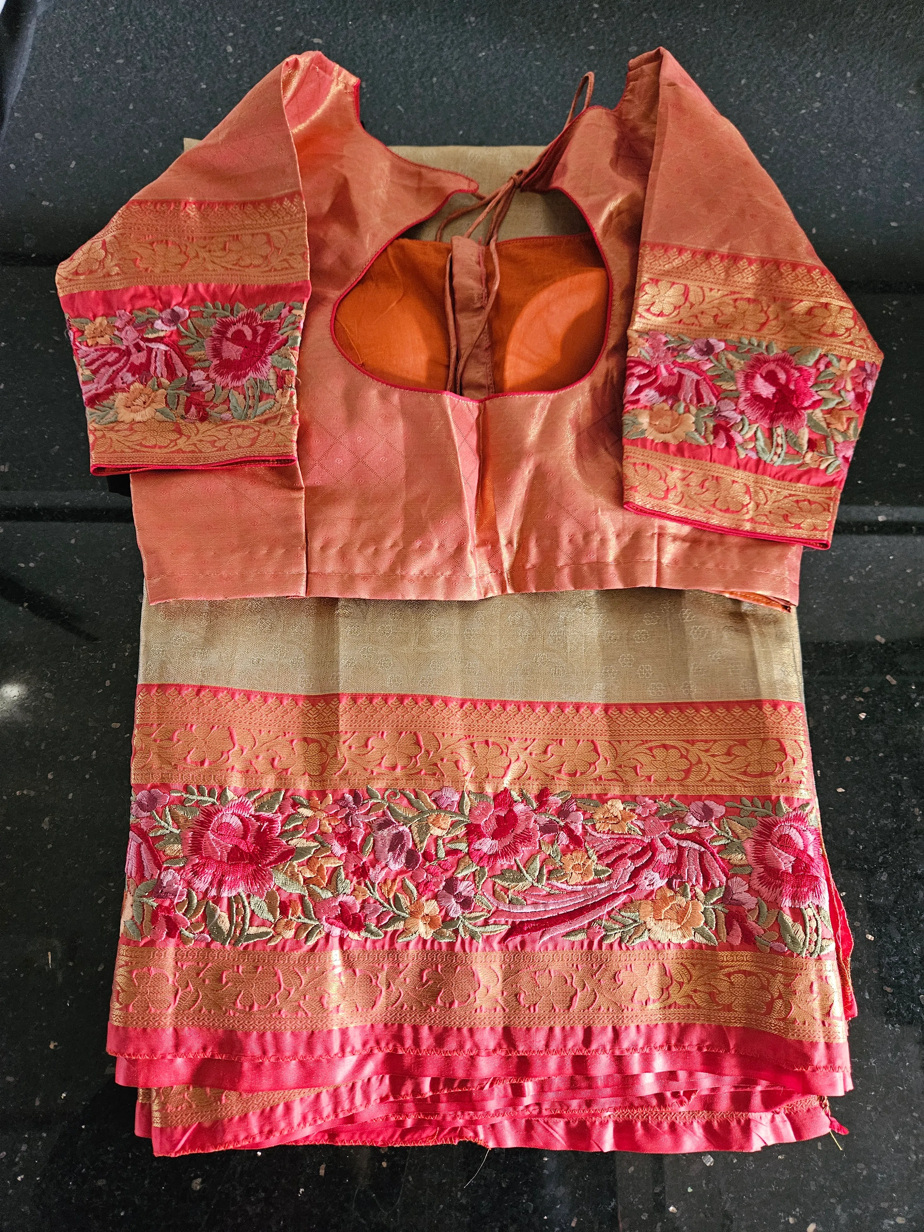 Handwoven pure Kanchipuram silk saree in peach and gold with intricate golden zari and floral embroidery, ideal for weddings.