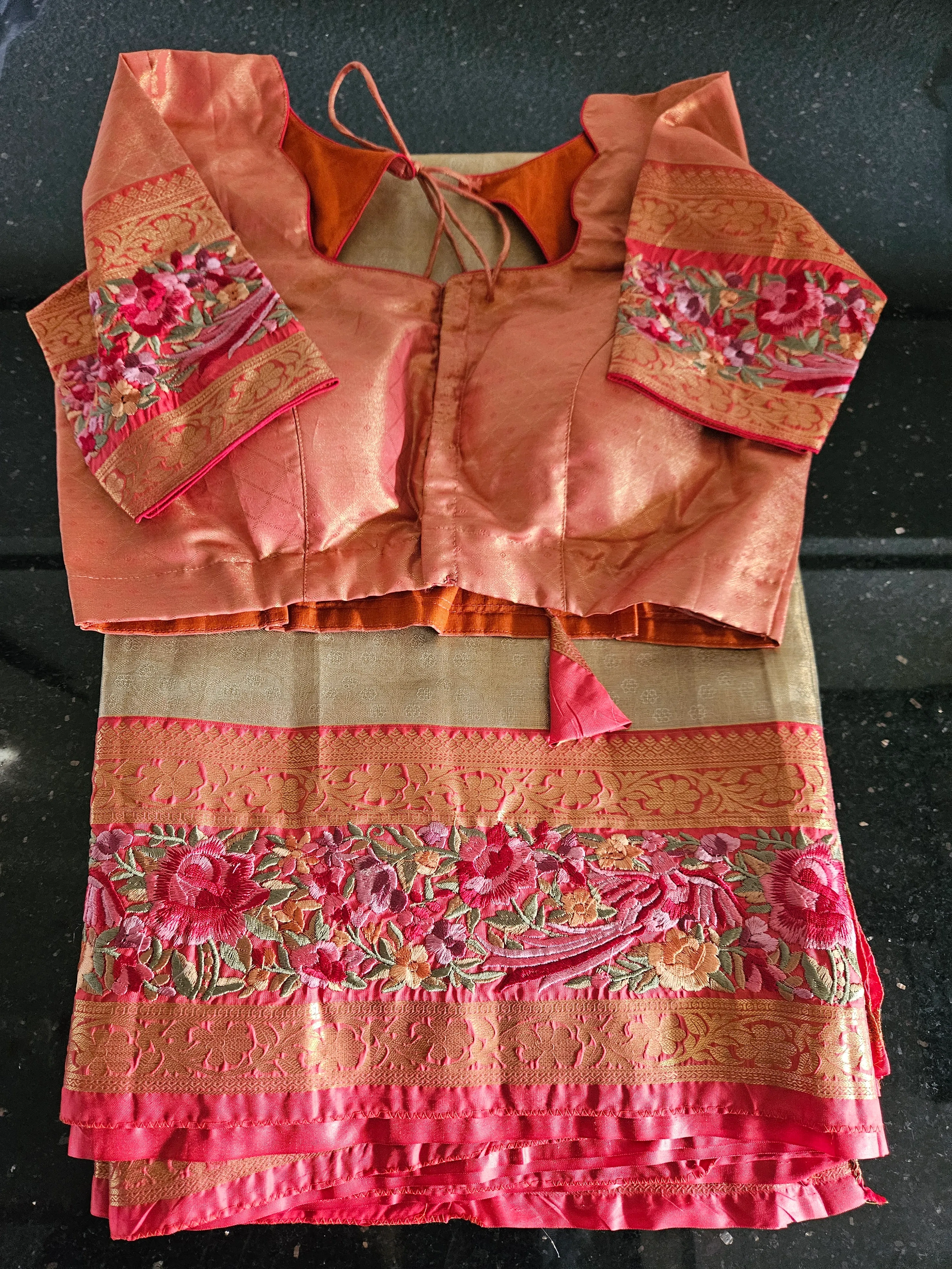 Handwoven pure Kanchipuram silk saree in peach and gold with intricate pink floral embroidery and golden zari border