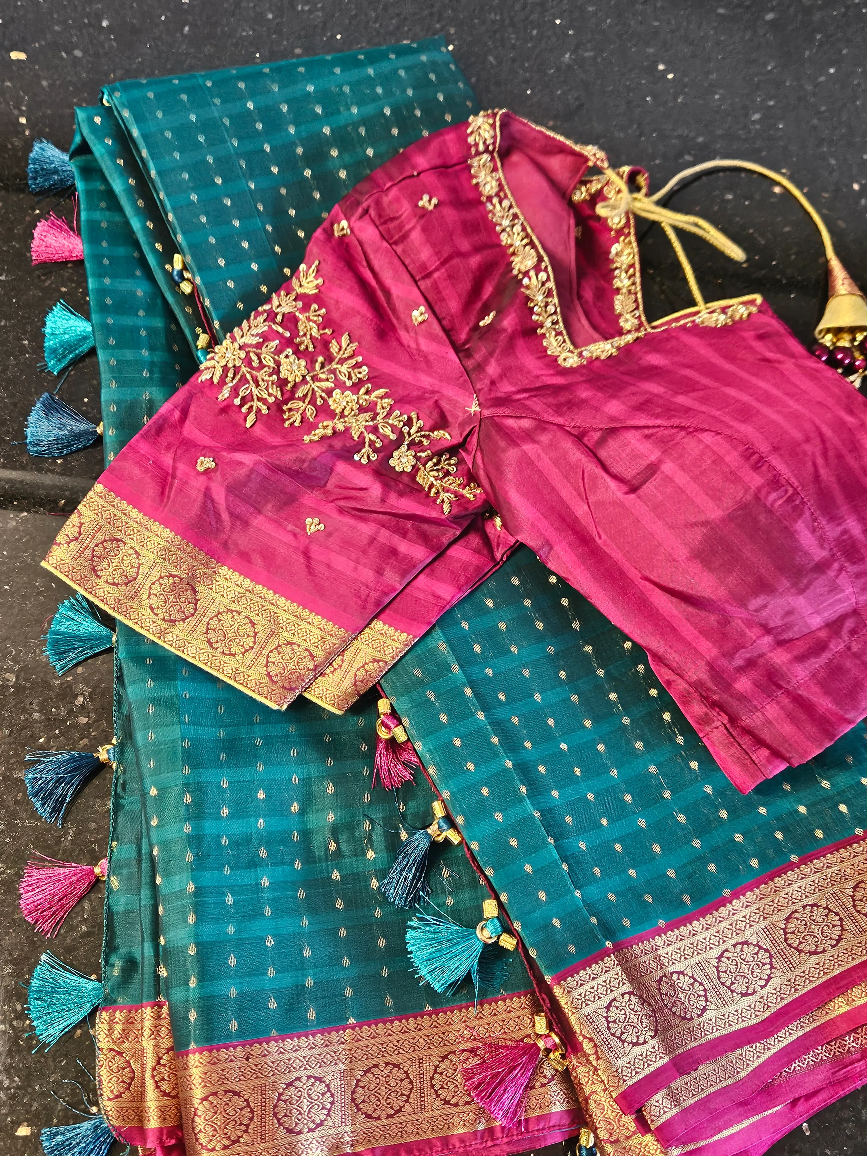 Handwoven pure Kanchipuram silk wedding saree in teal with gold and silver zari work, magenta blouse, and tassel border