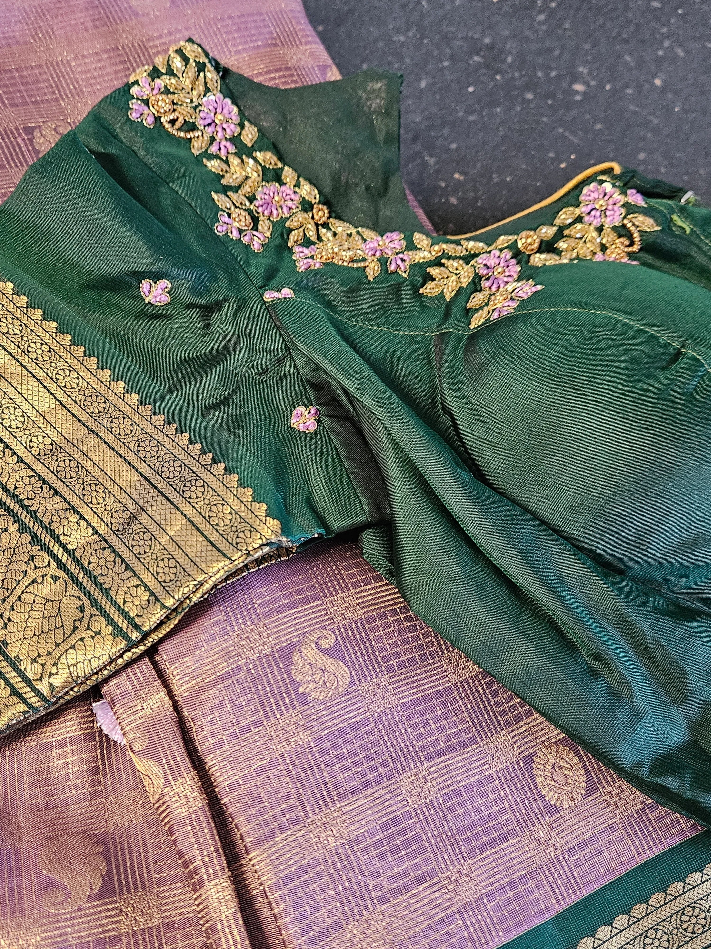 Handwoven pure Kanchipuram silk saree in rich green and purple with gold and silver zari, floral embroidery on blouse.