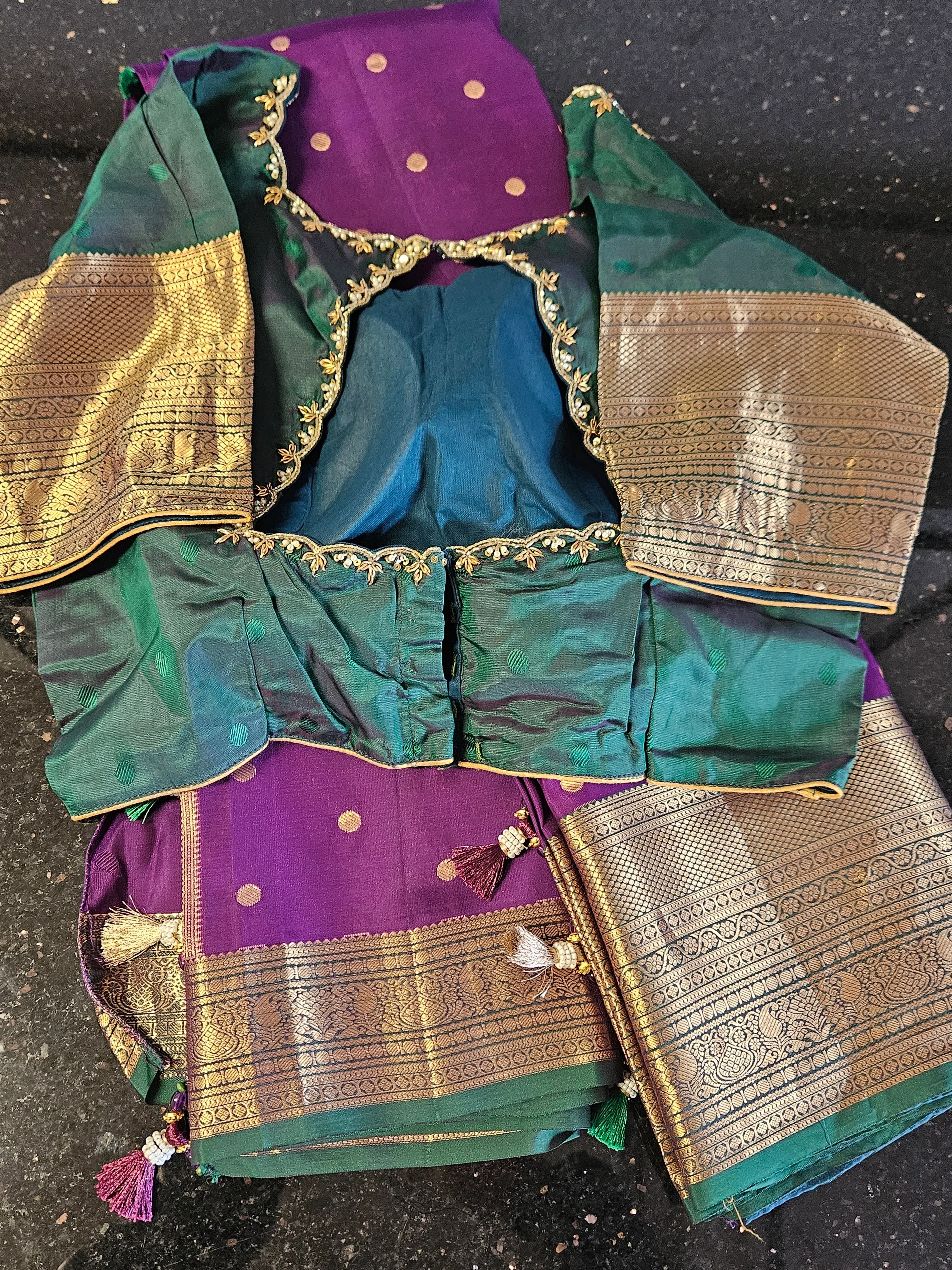 Handwoven Kanchipuram silk saree in green and purple with gold zari work, rich pallu, and intricate border details