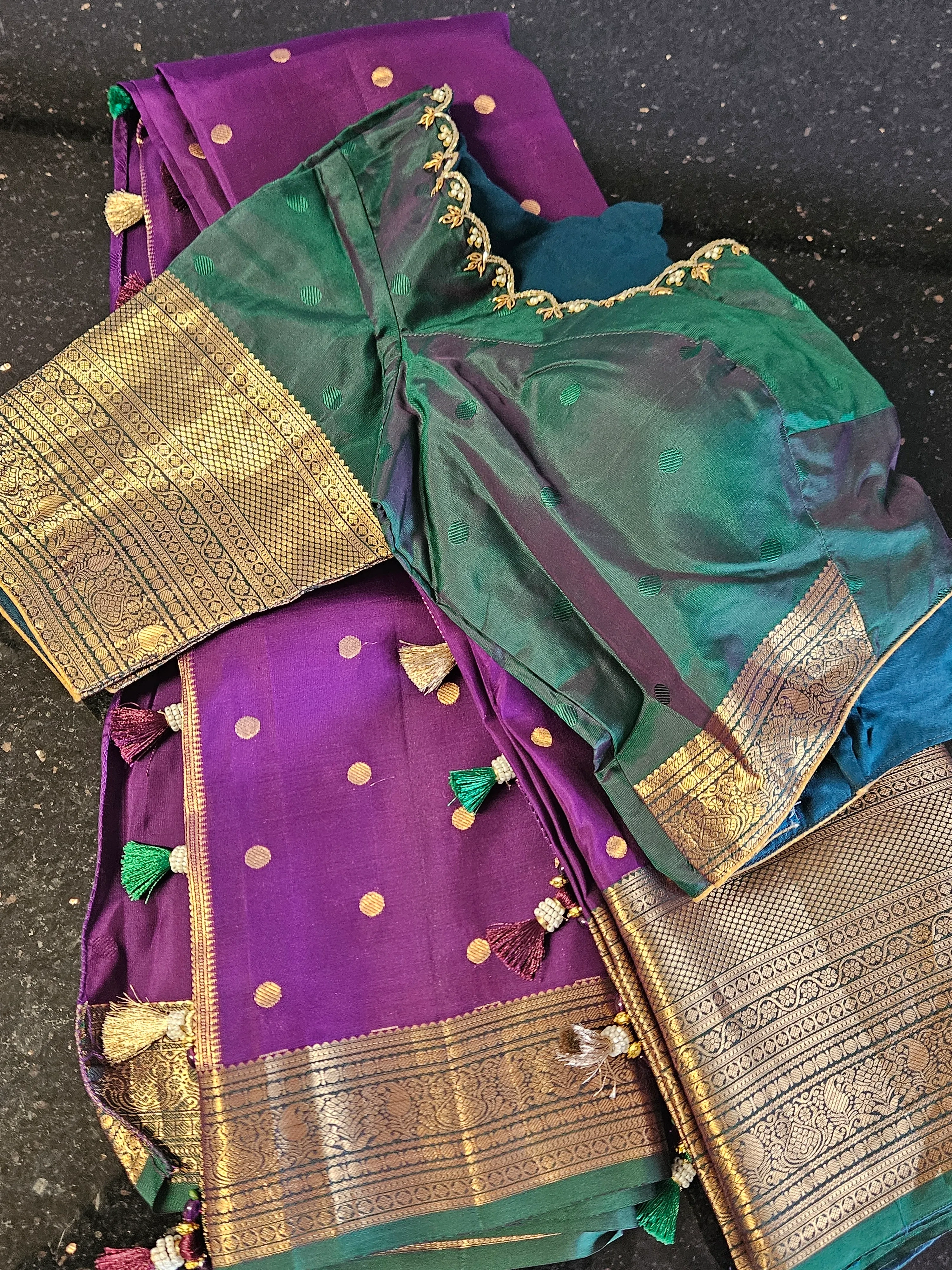 Handwoven Kanchipuram silk saree in purple and green with gold zari work, polka dots, and intricate border detailing