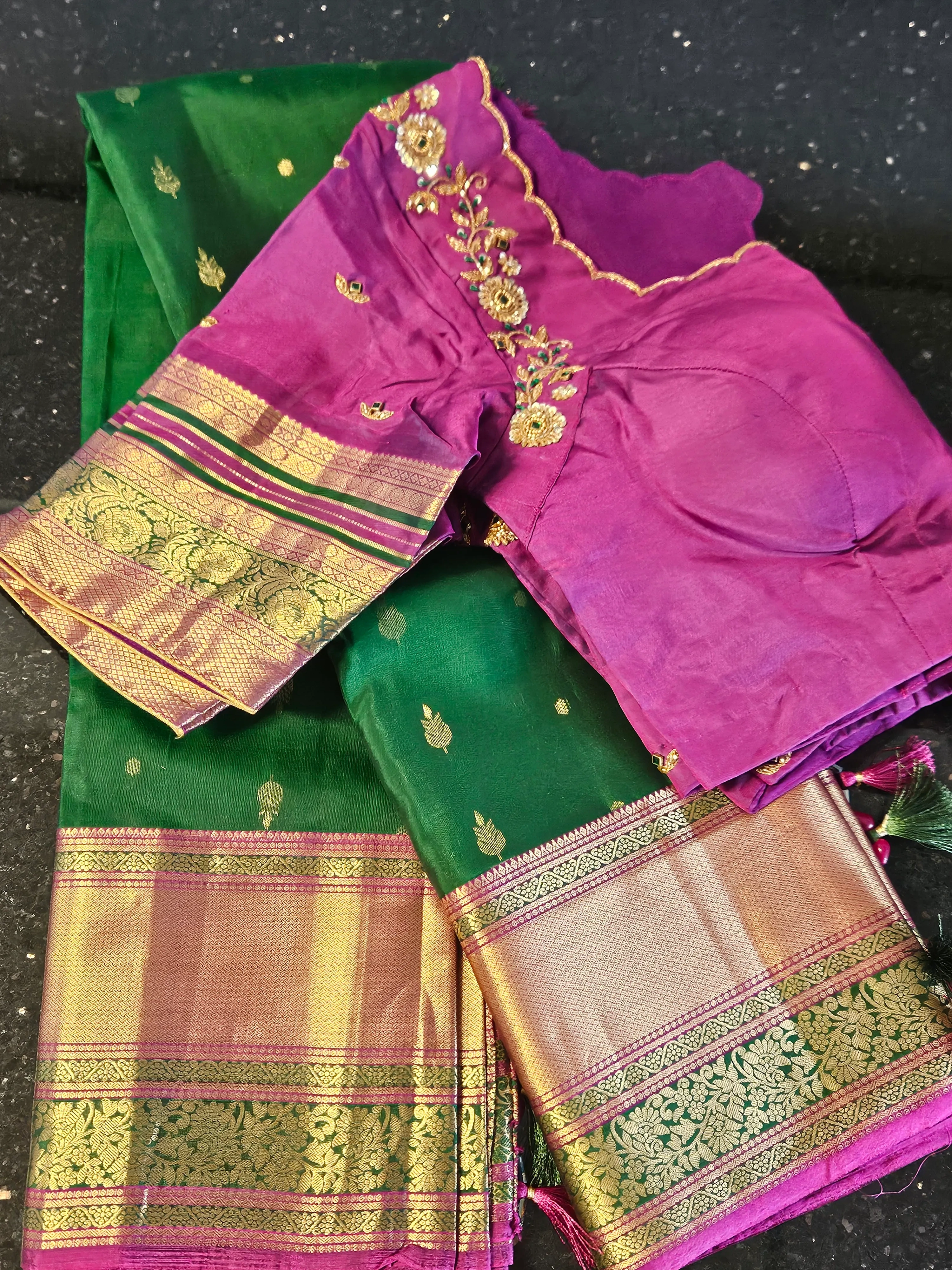 Pure Kanchipuram silk saree in emerald green with gold zari work, paired with a purple embroidered blouse, ideal for bridal wear.