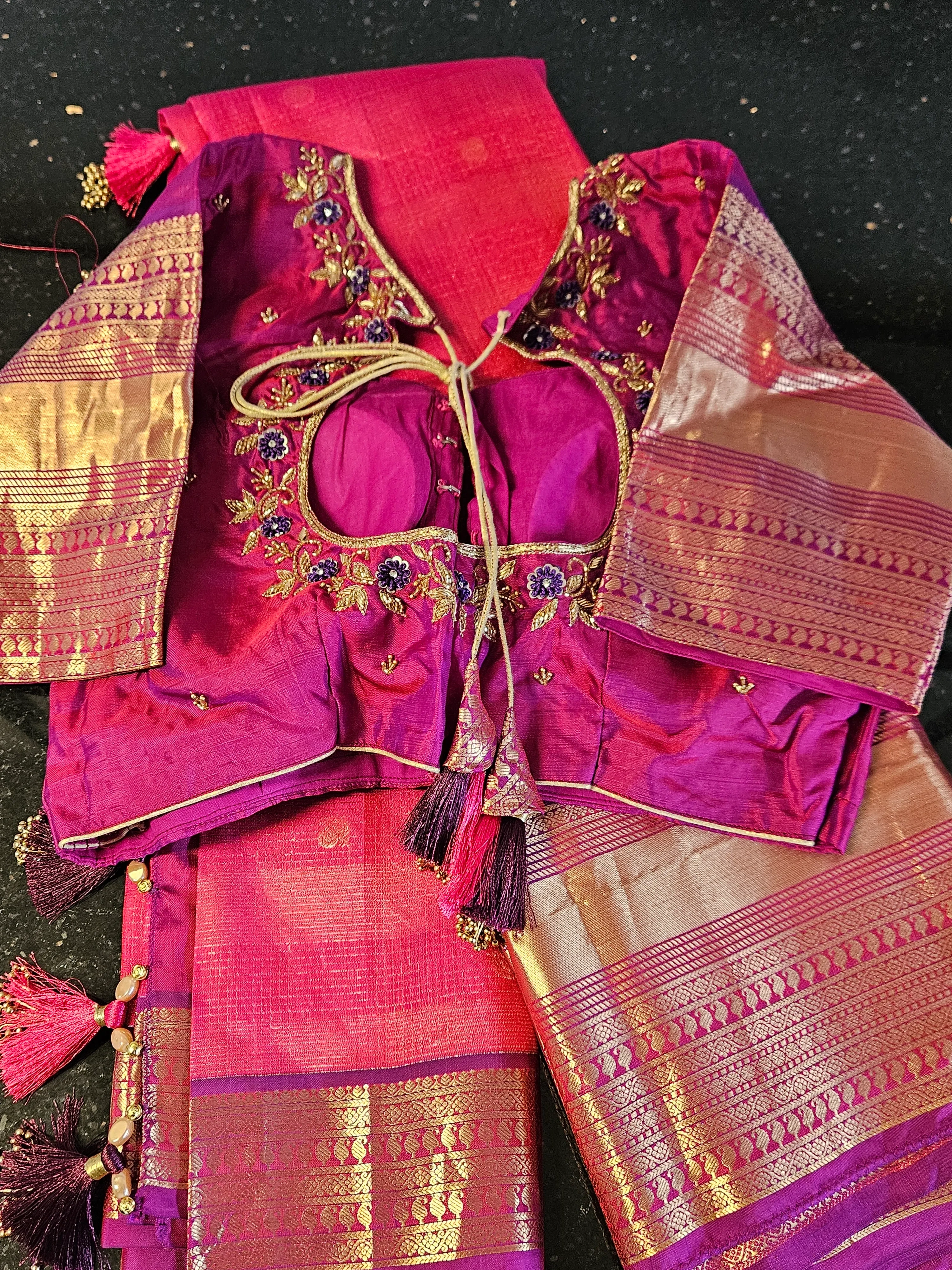Handwoven pure Kanchipuram silk saree in vibrant magenta with gold and silver zari, paired with an embroidered blouse.