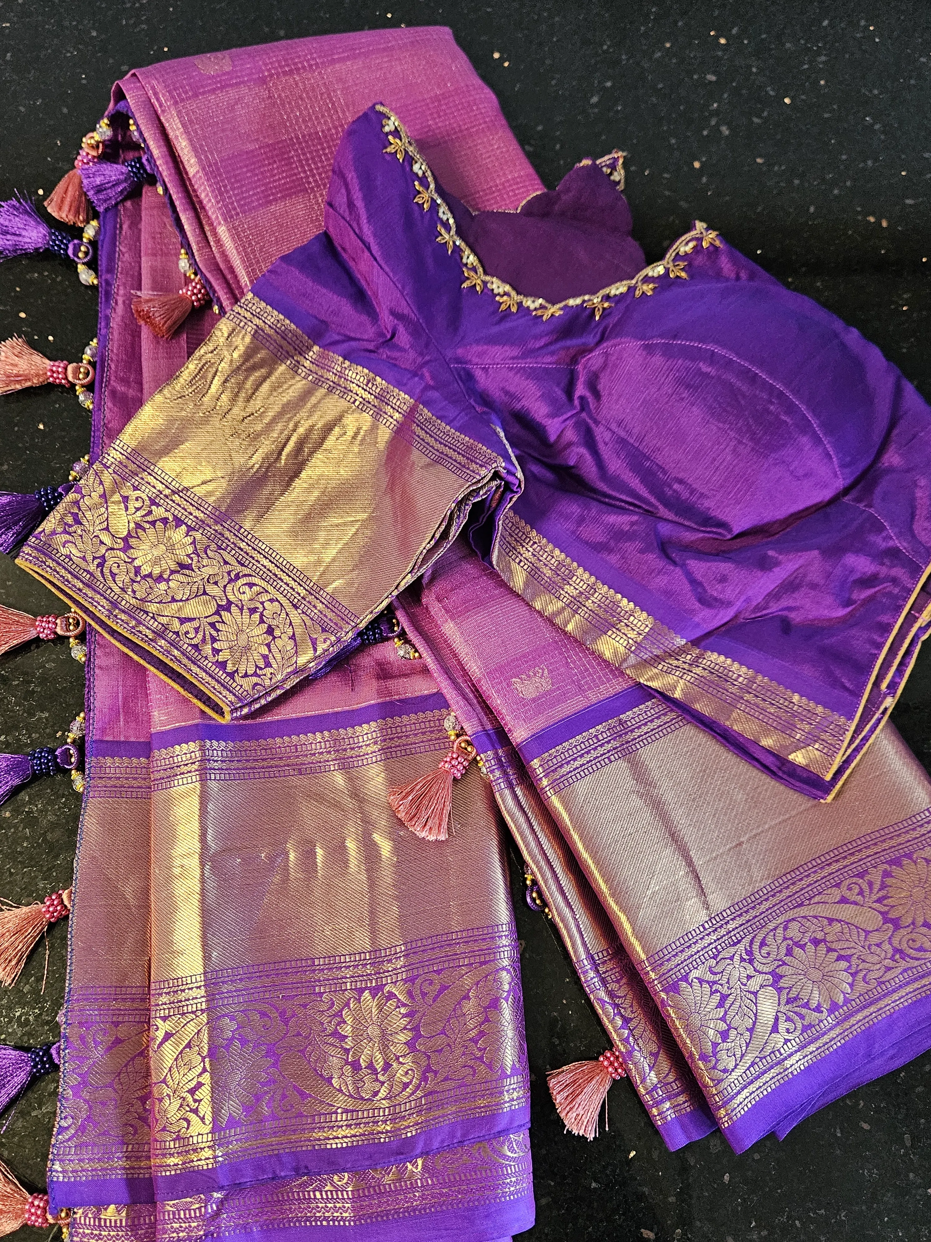 Pure Kanchipuram silk wedding saree in rich purple with gold handwoven zari work and traditional floral motifs, bridal wear