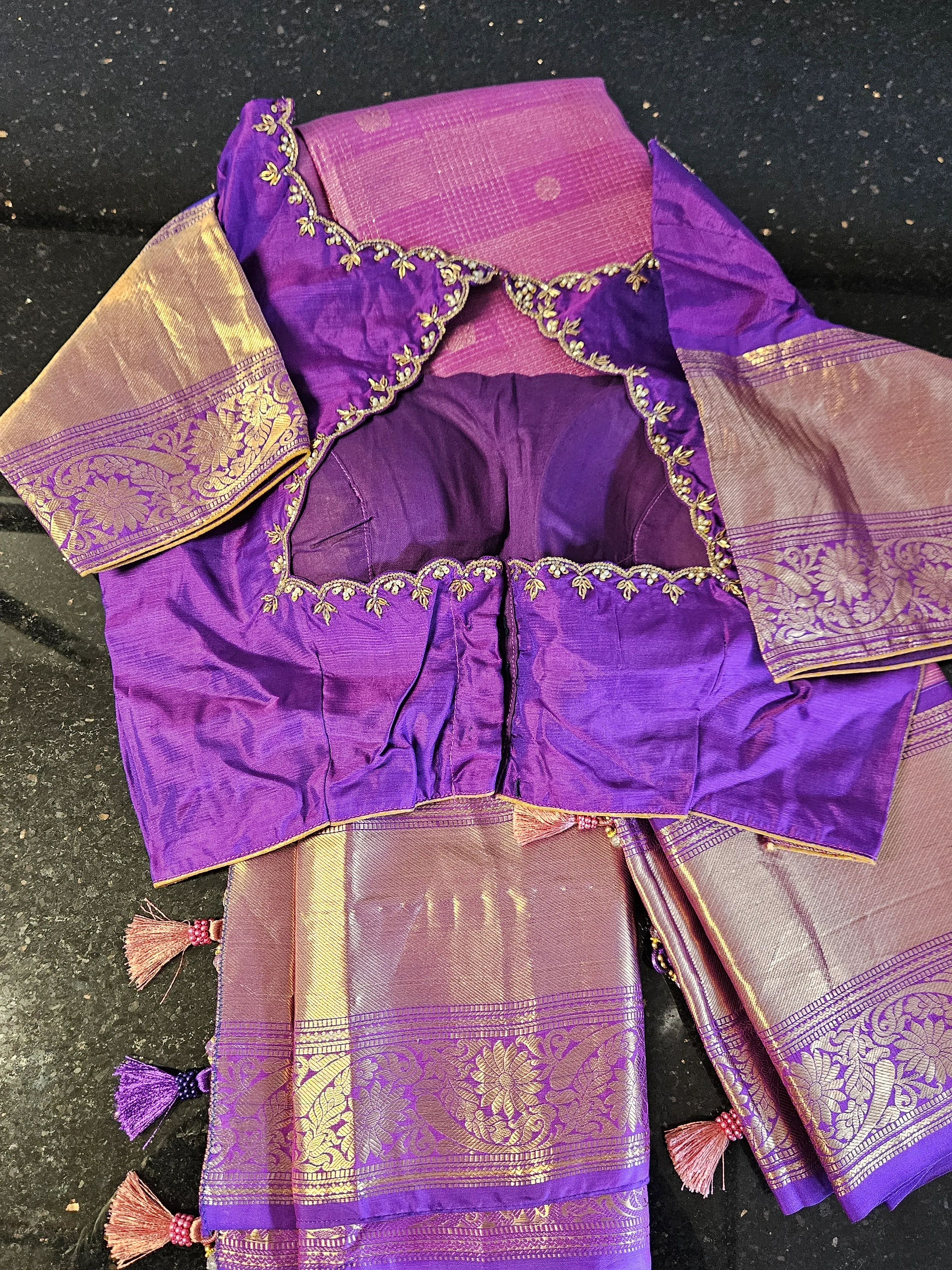 Pure Kanchipuram silk wedding saree in rich purple with gold zari handwoven borders, paired with matching embroidered blouse.