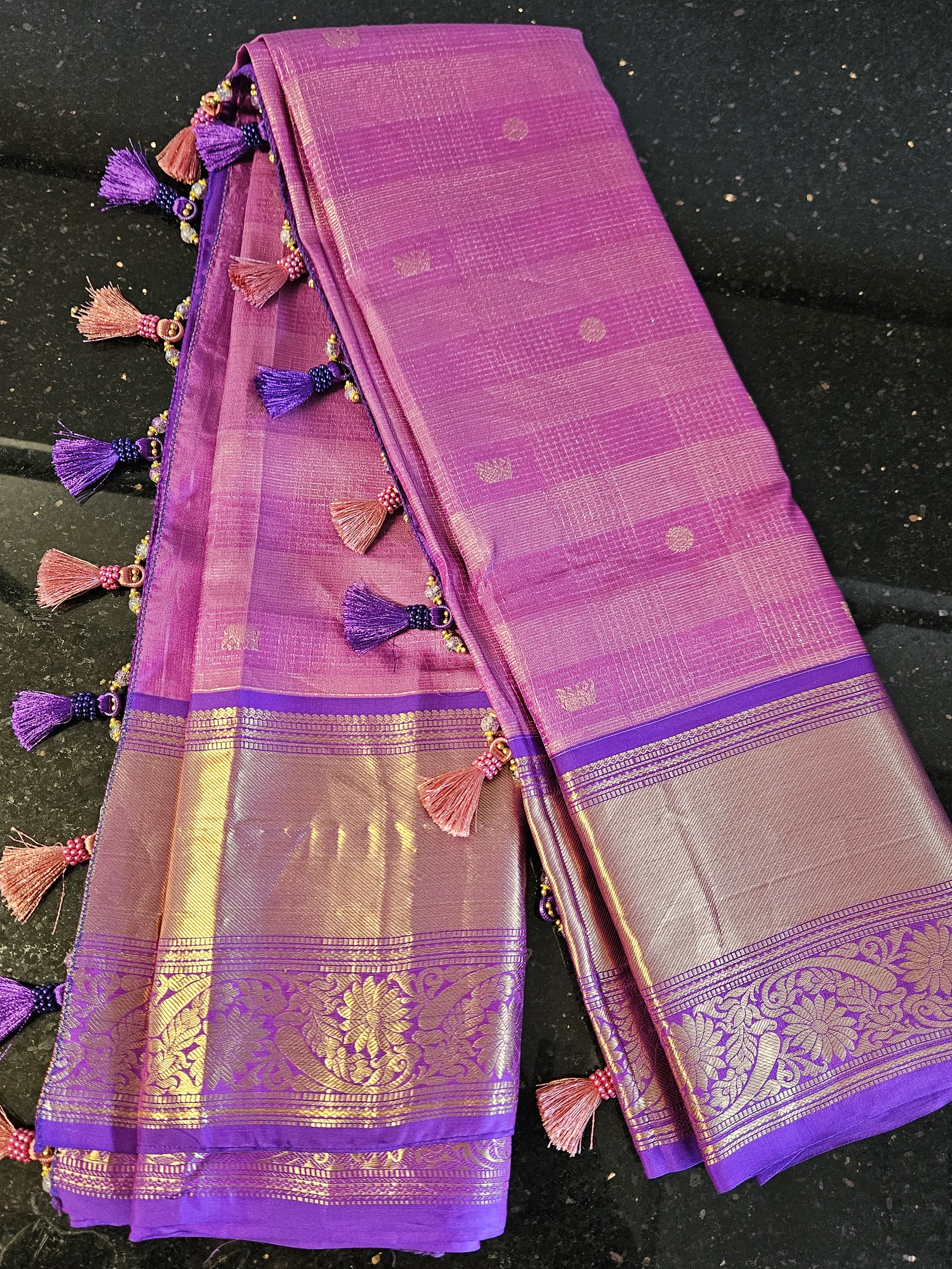 Pure Kanchipuram silk wedding saree in vibrant purple with gold zari handwoven motifs, intricate border, and tassel accents