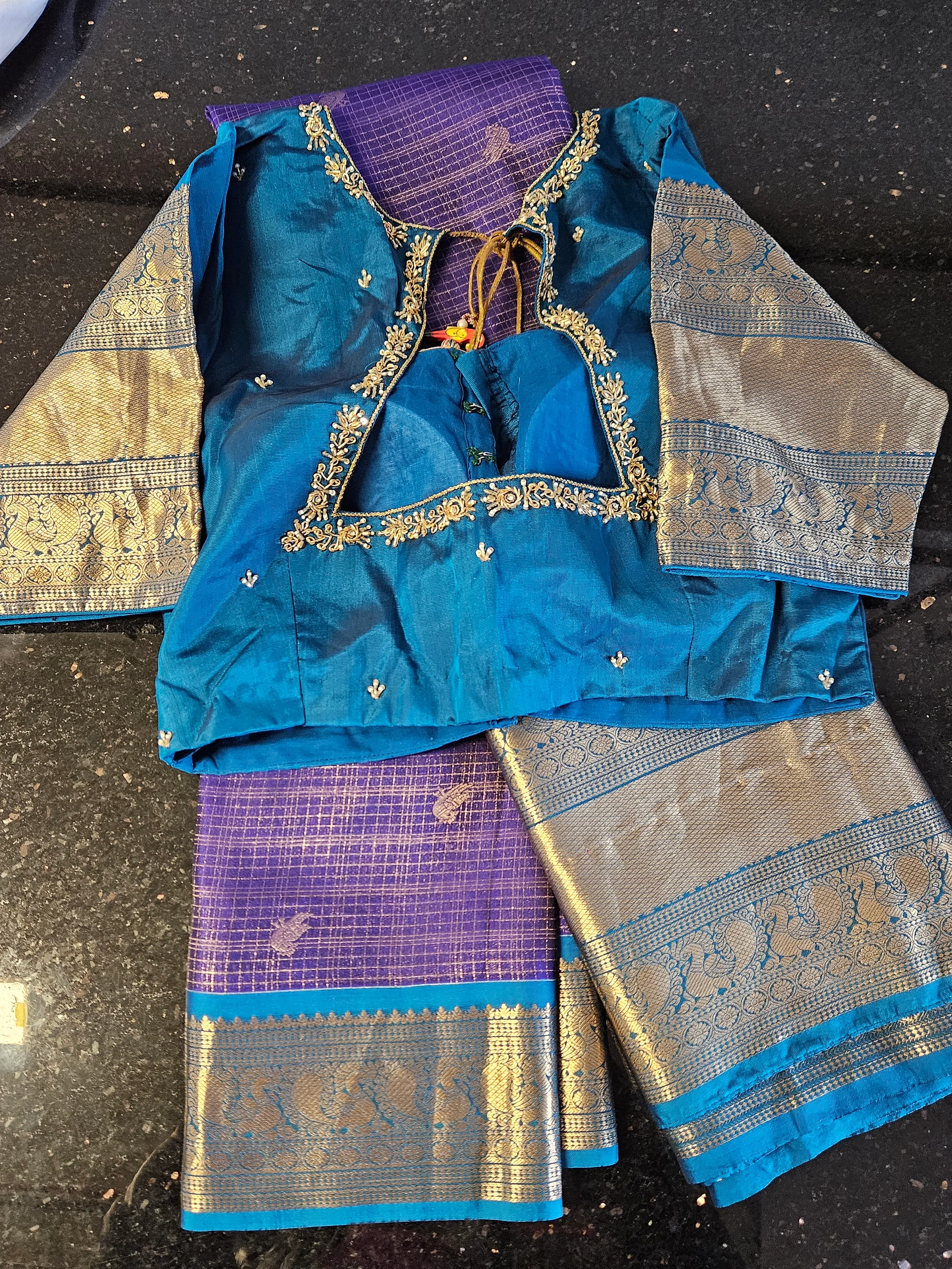 Handwoven pure Kanchipuram silk wedding saree in blue and purple with gold zari borders and multicolor motifs, blouse included