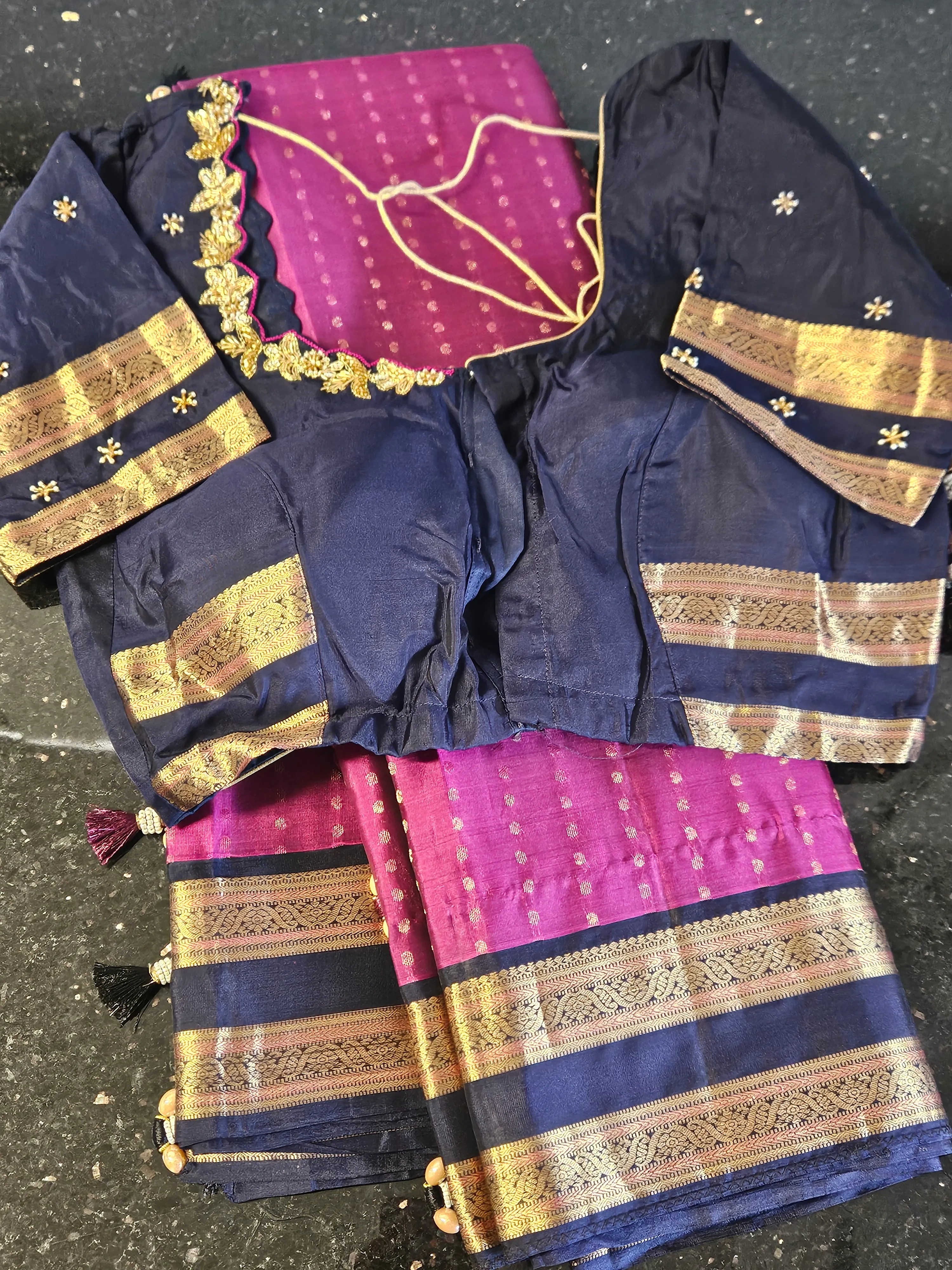 Handwoven pure Kanchipuram silk bridal saree in magenta with gold zari temple motifs, paired with navy blue blouse featuring gold borders.