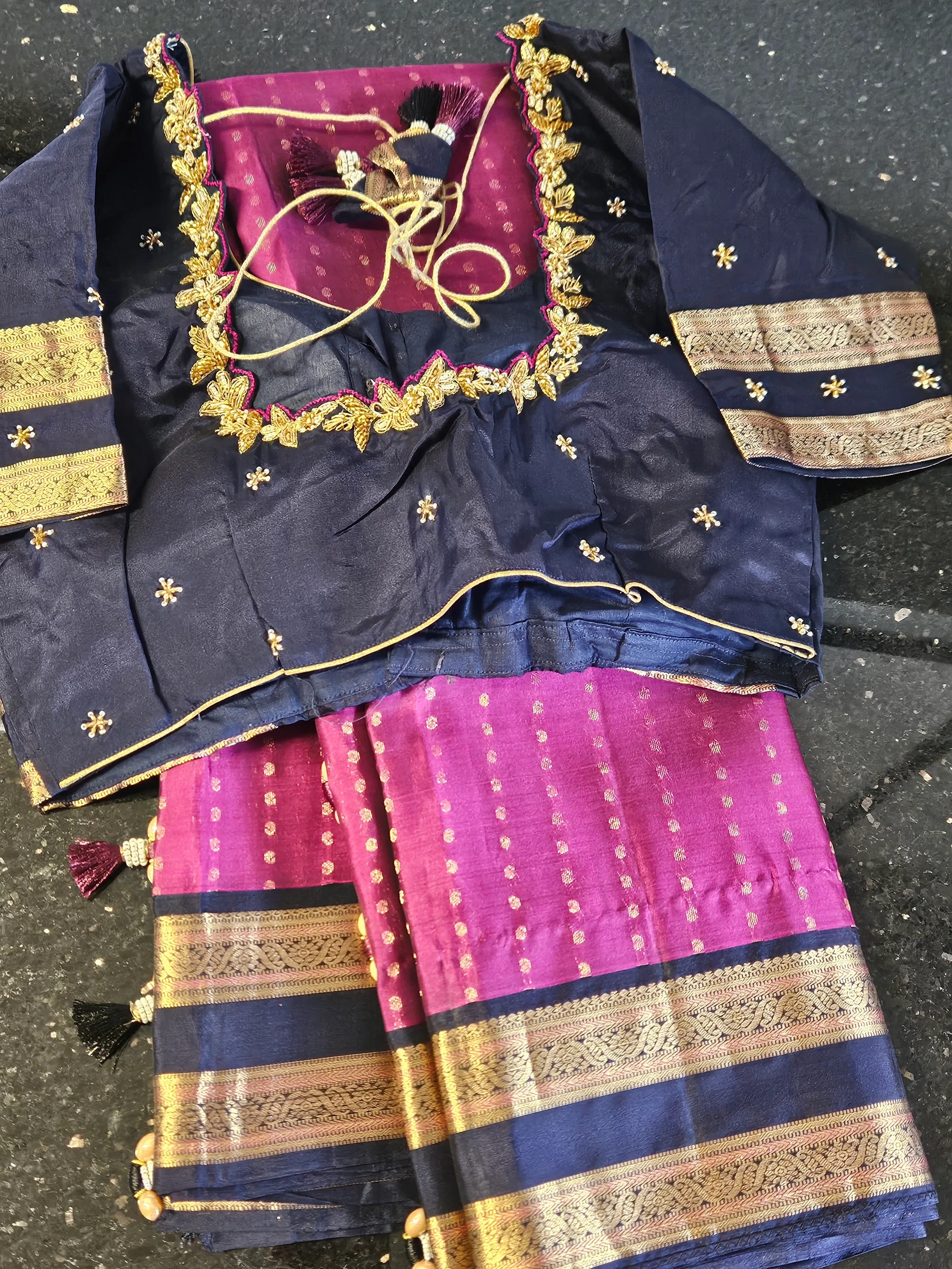 Handwoven pure Kanchipuram silk bridal saree in deep purple and magenta with gold zari temple motifs and matching blouse.