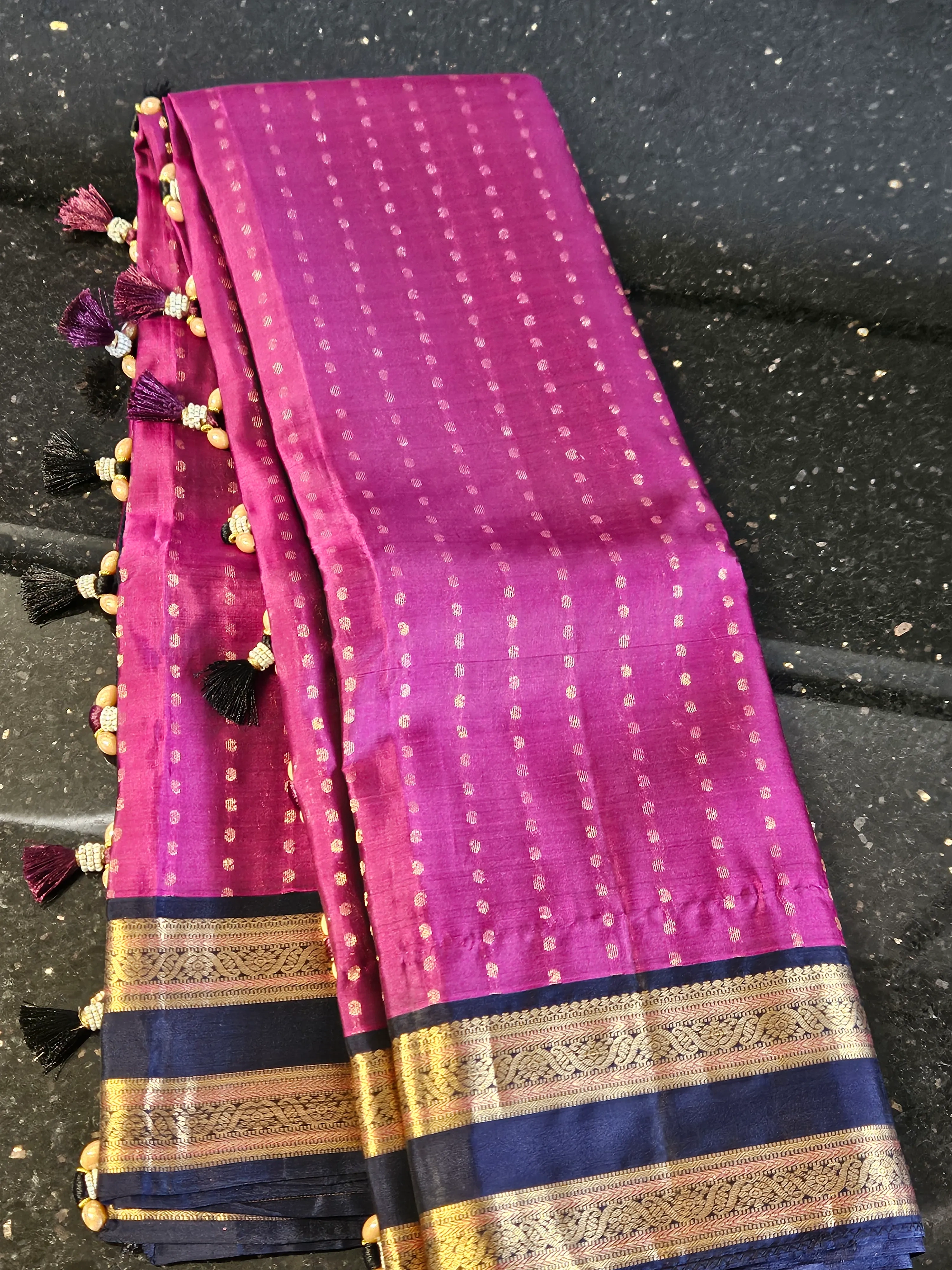 Handwoven pure Kanchipuram silk bridal saree in rich magenta with gold zari temple motifs and navy blue border detailing