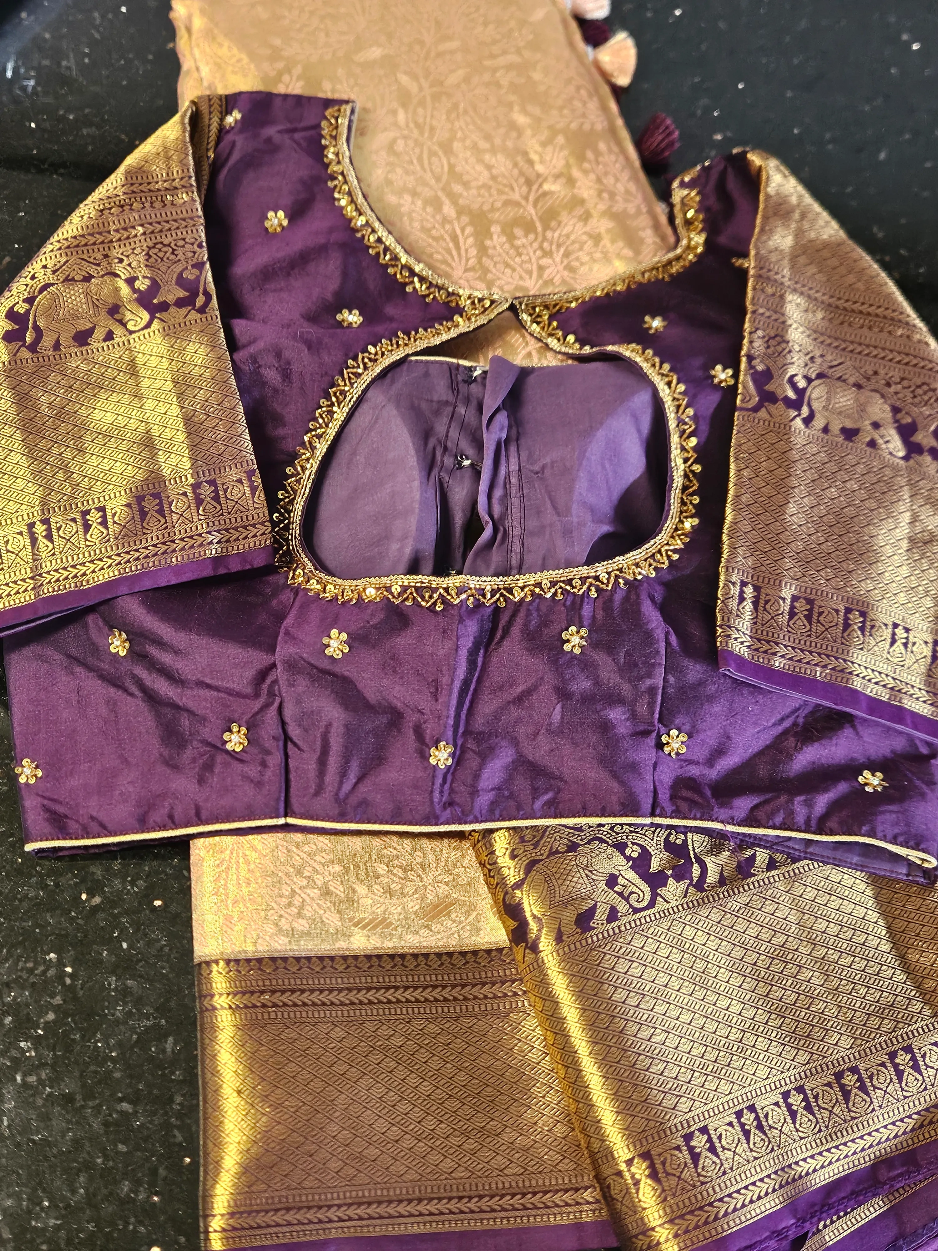 Pure Kanchipuram silk wedding saree in rich purple with handwoven gold and silver zari motifs, paired with matching blouse.