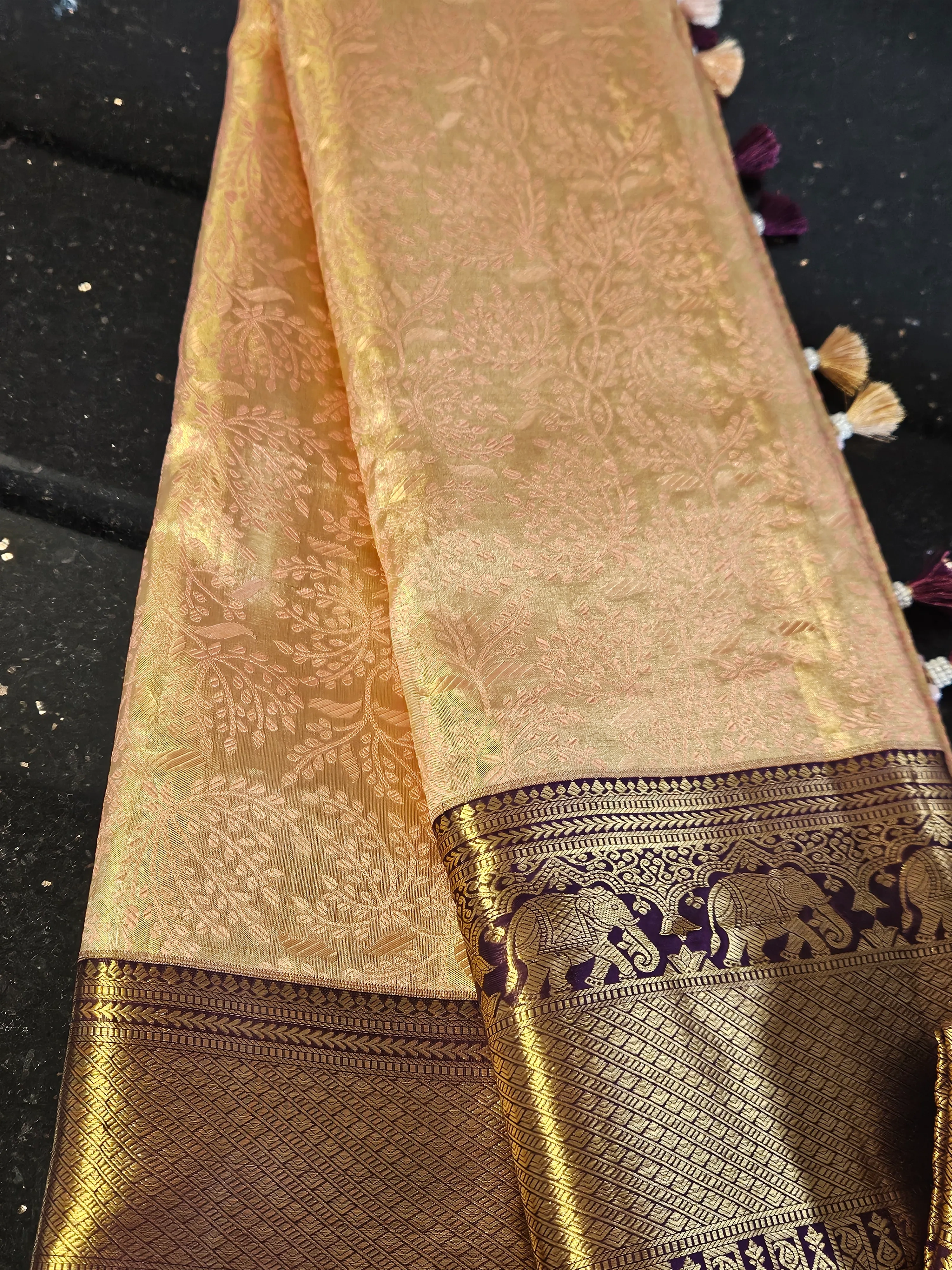 Pure Kanchipuram silk wedding saree in gold with intricate handwoven gold and silver zari motifs and elephant border detailing