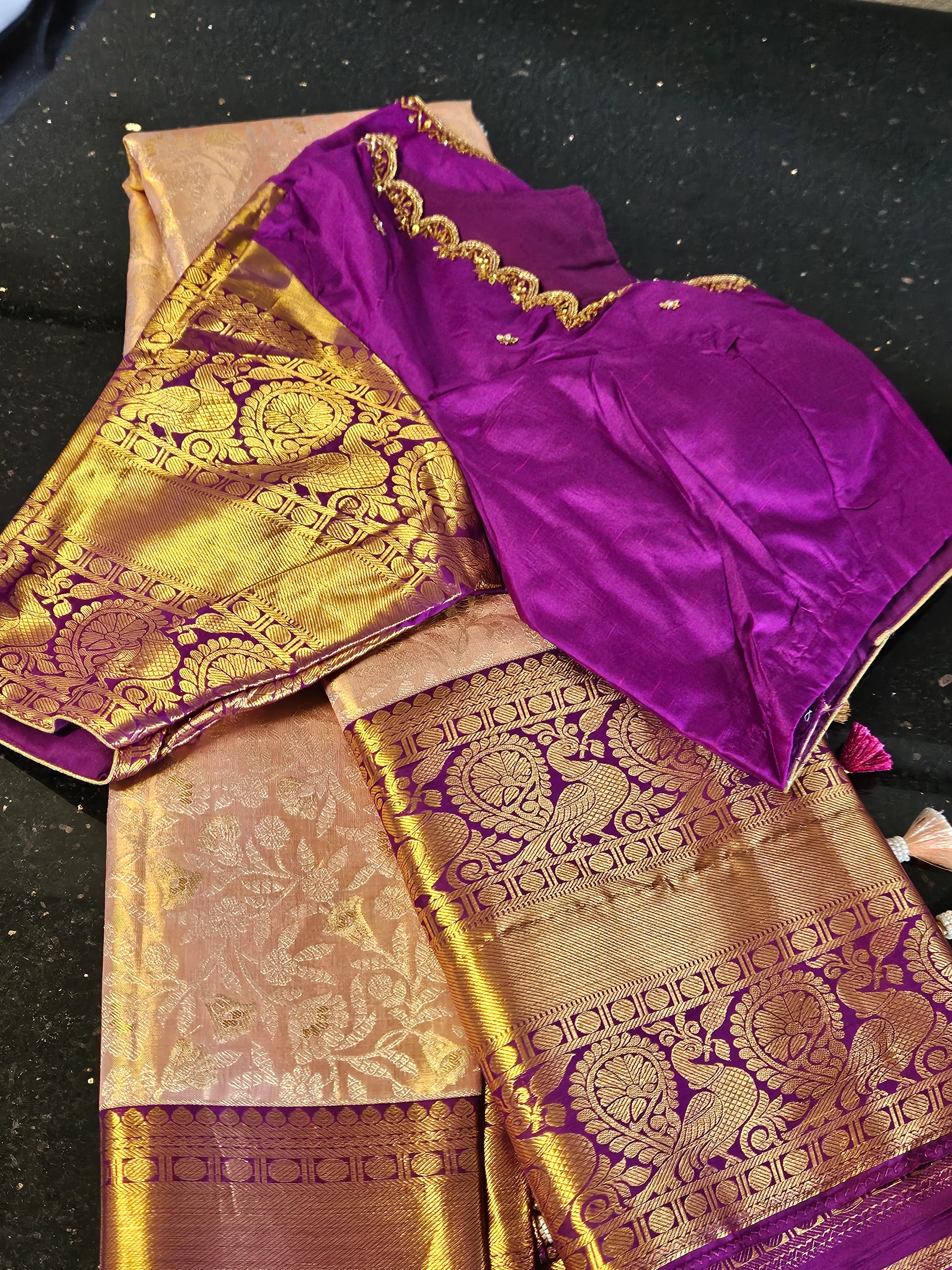 Handwoven Kanchipuram silk saree in rich purple and gold with intricate zari peacock motifs, ideal for weddings and festivals