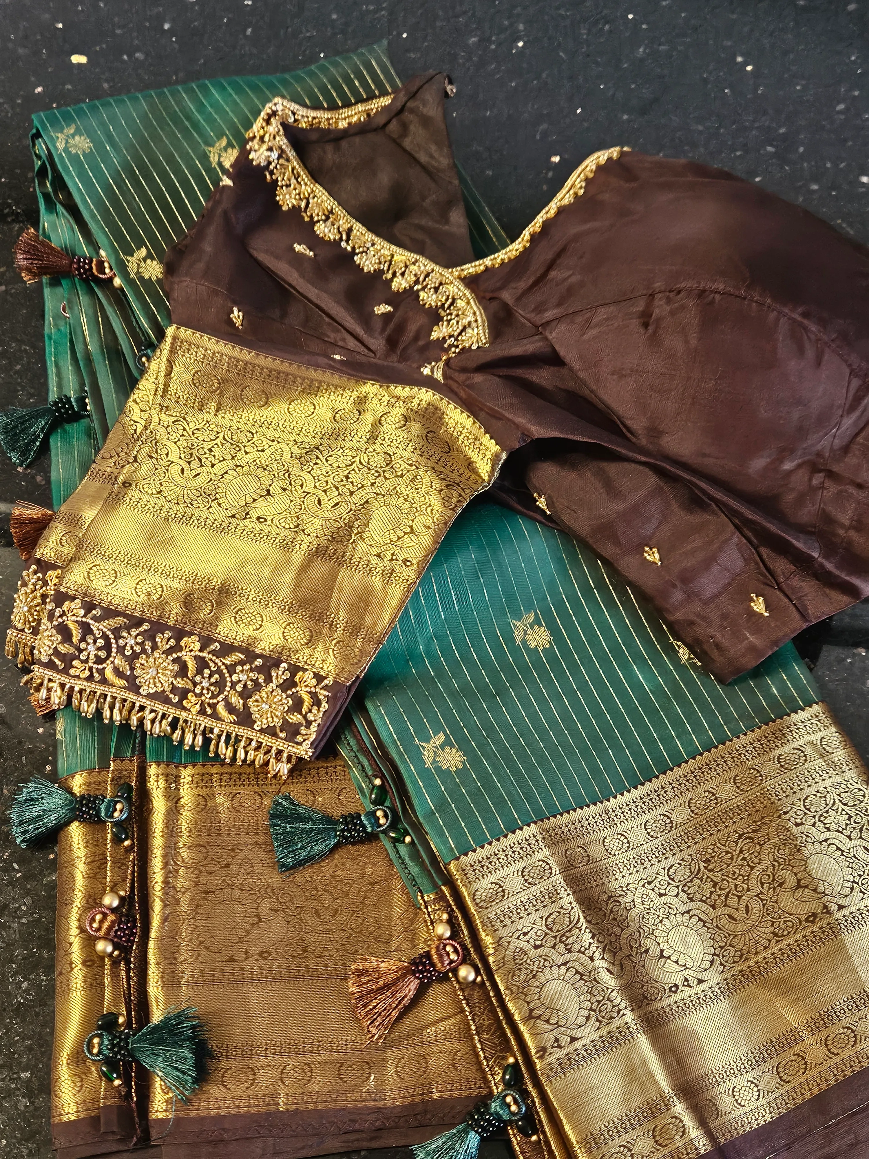 Pure Kanchipuram silk wedding saree in green with intricate handwoven gold zari work, paired with a rich maroon blouse.
