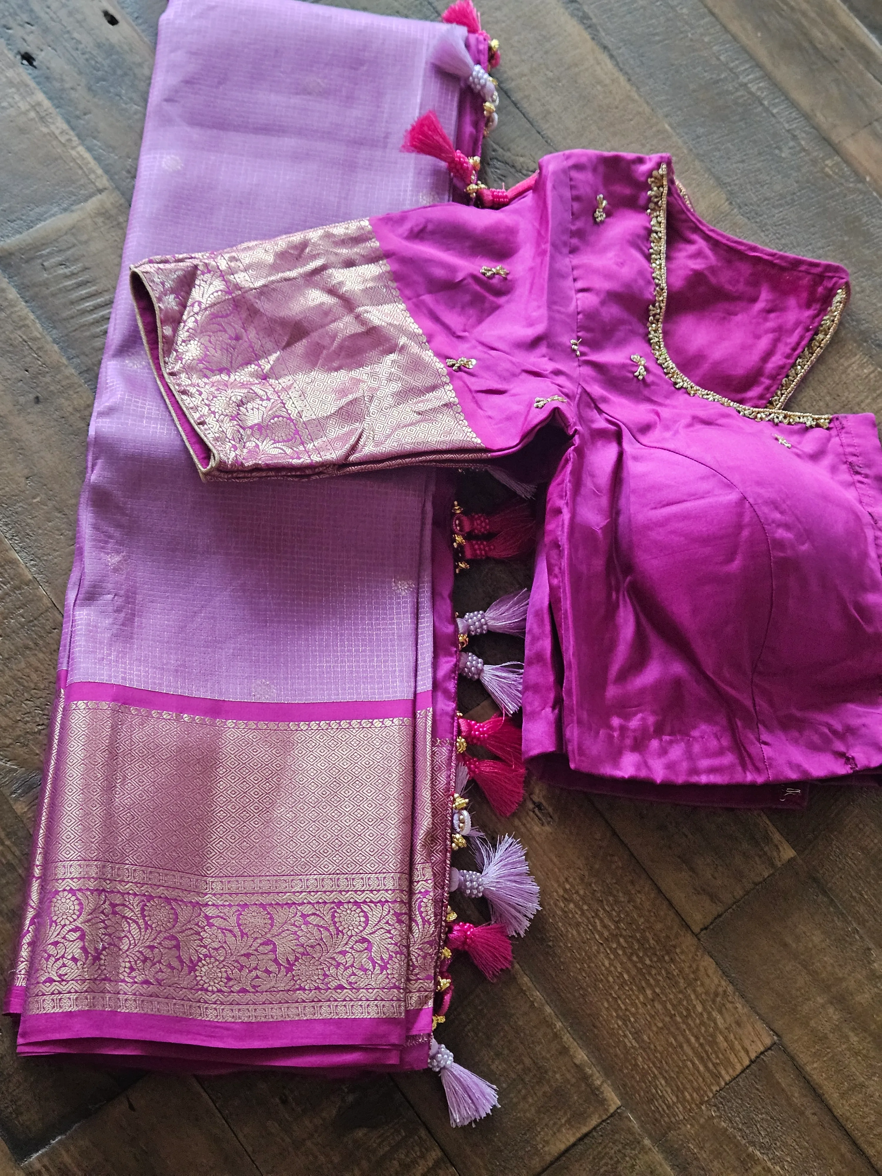 Pure Kanchipuram silk wedding saree in vibrant magenta with gold zari border, paired with matching blouse and tassels.