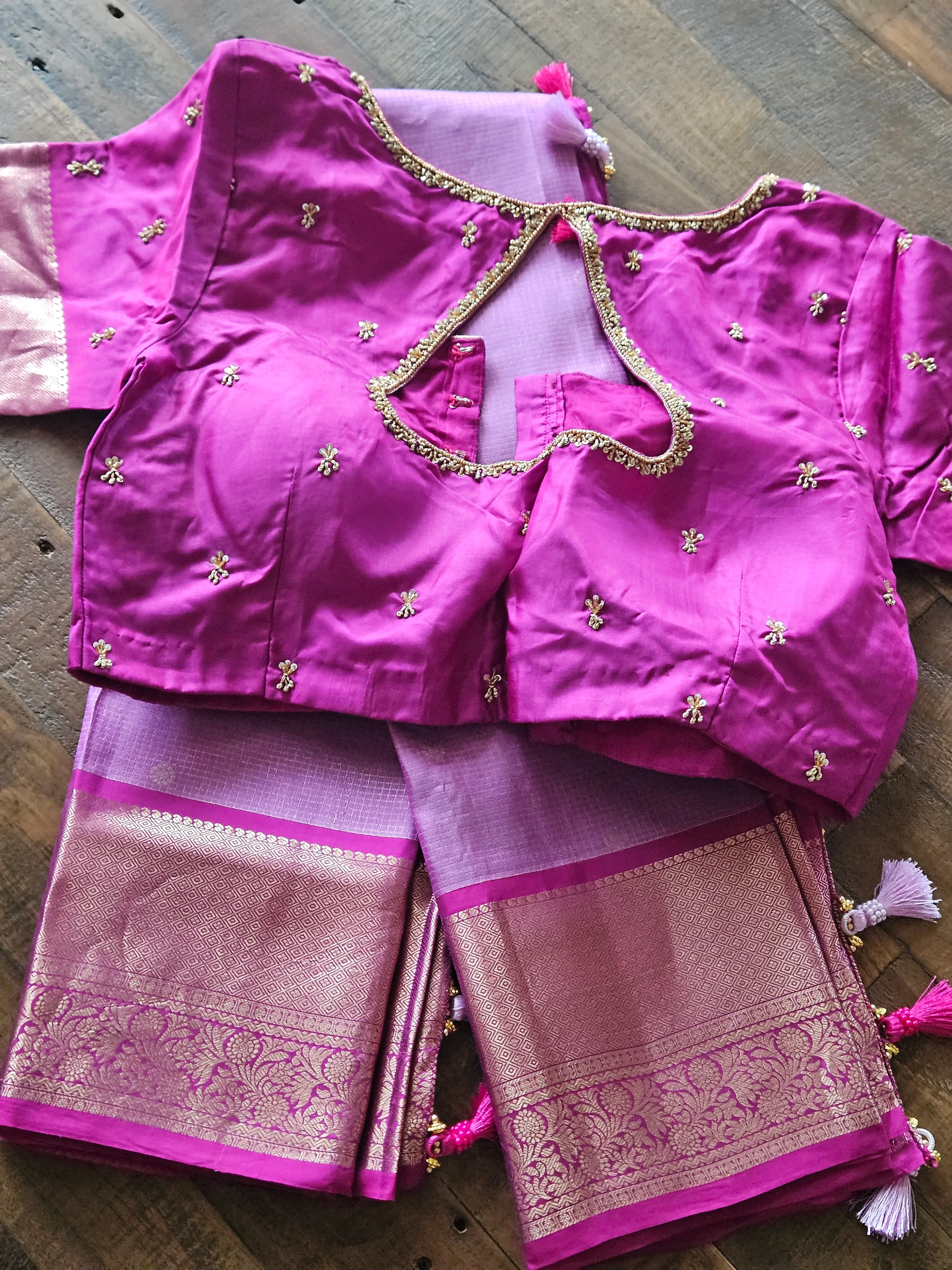 Pure Kanchipuram silk wedding saree in vibrant pink with handwoven gold zari border, paired with matching embroidered blouse.