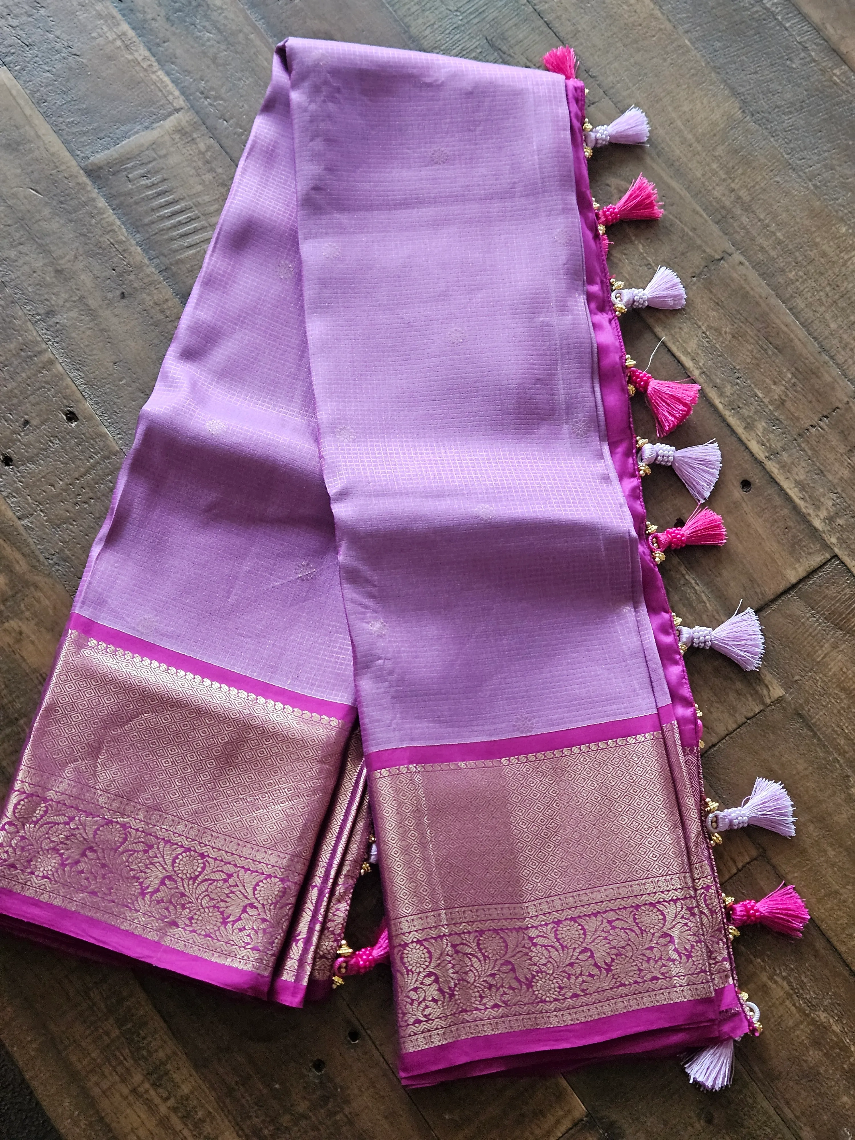Pure Kanchipuram silk wedding saree in lavender and pink with handwoven gold zari border and colorful tassels