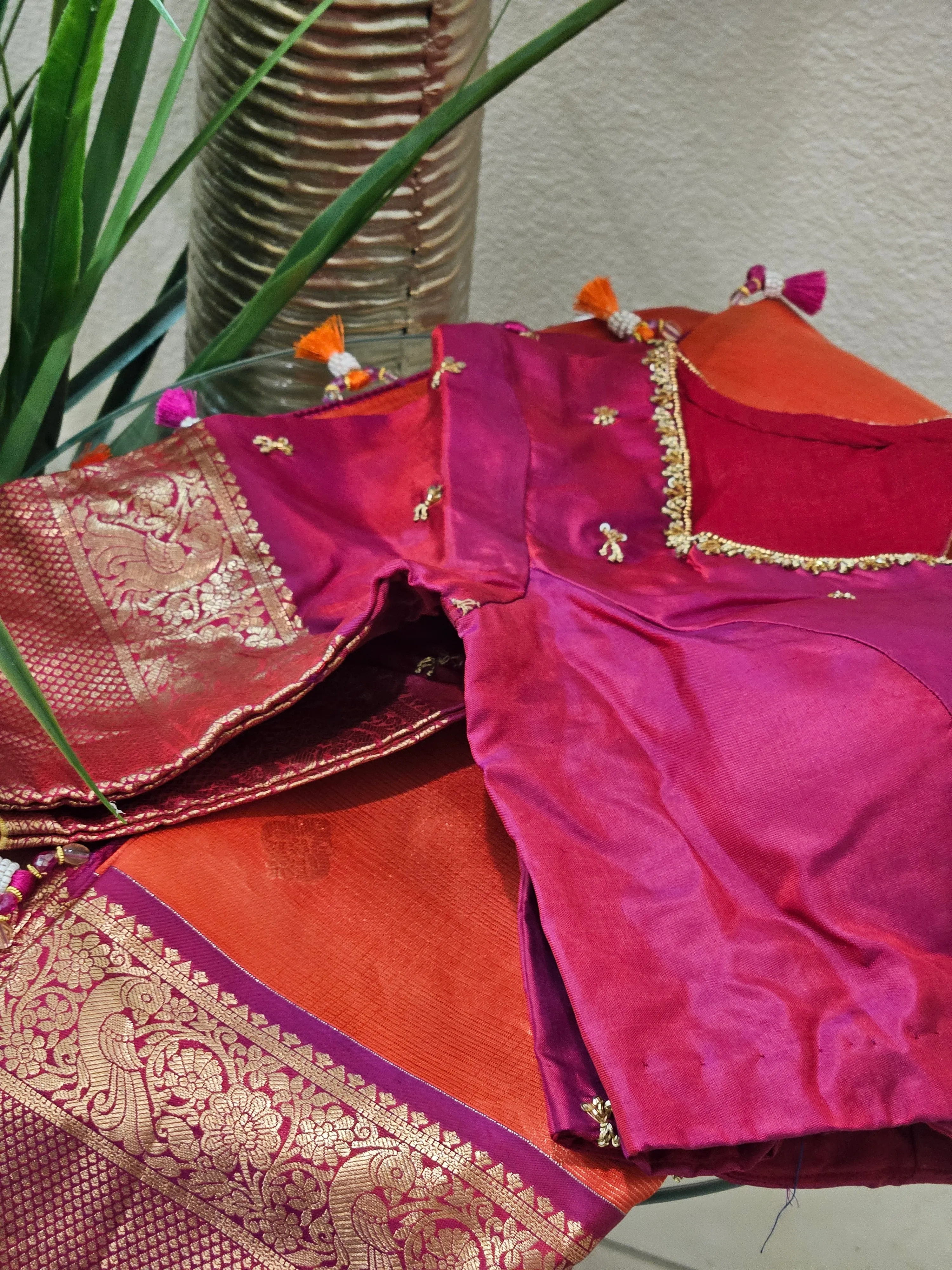 Handwoven pure Kanchipuram silk wedding saree in rich magenta with gold and silver zari floral motifs, paired with matching blouse.