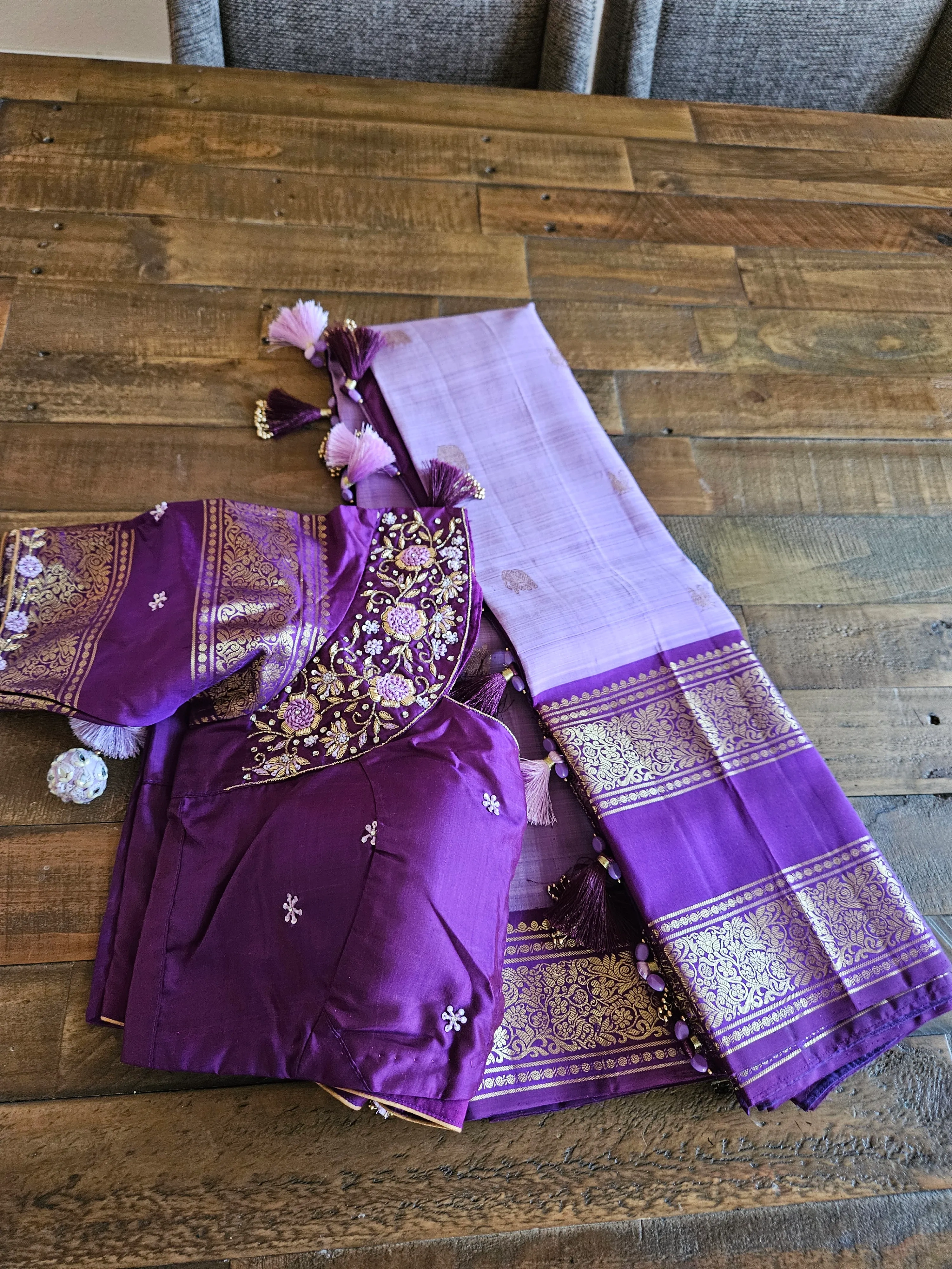 Pure Kanchipuram silk saree in rich purple with gold and silver zari borders, intricate blouse embroidery, perfect for weddings.