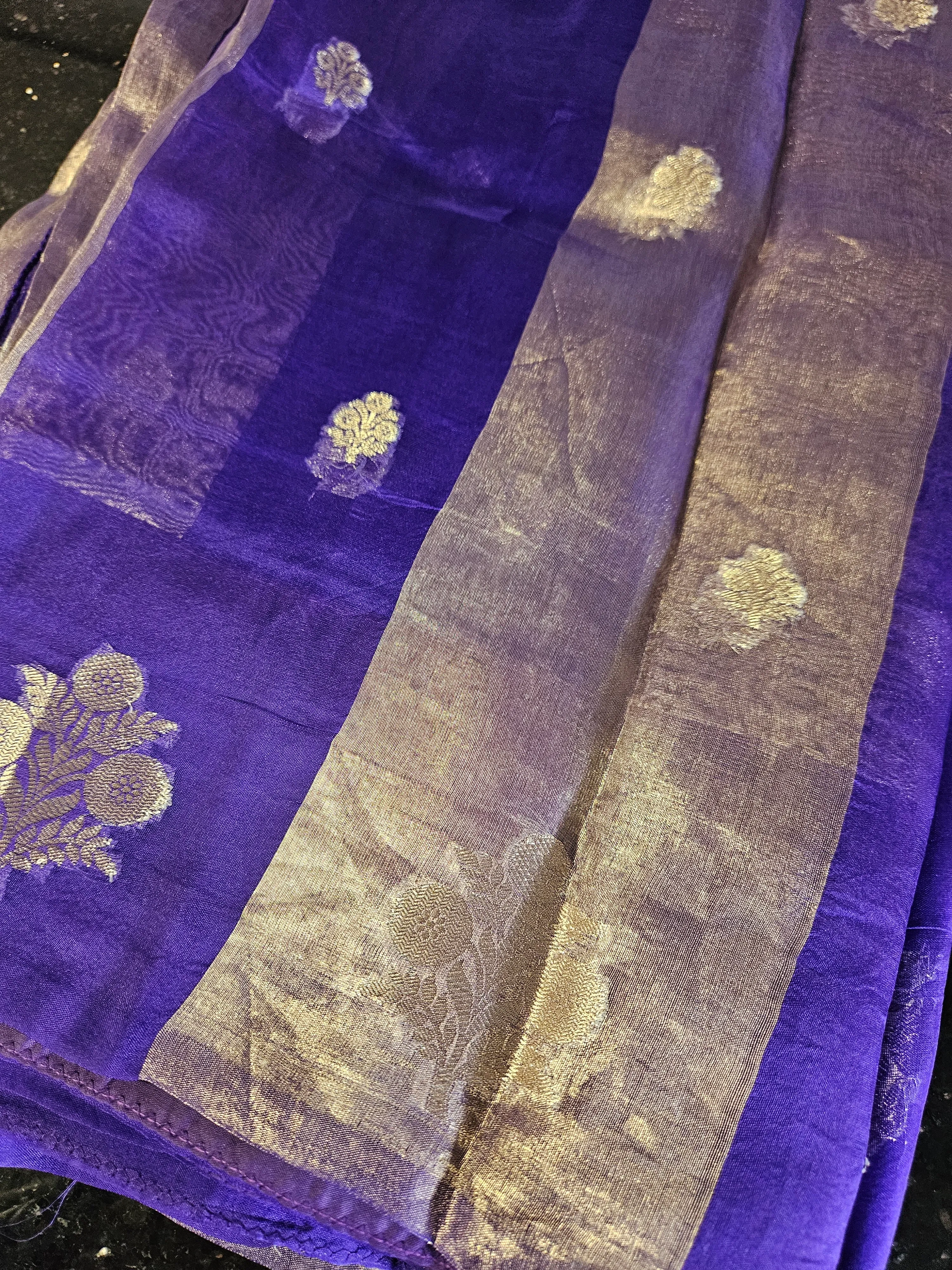 Pure Banarasi Kora tissue silk saree in royal purple with gold zari floral motifs and shimmering gold border, ideal for weddings.
