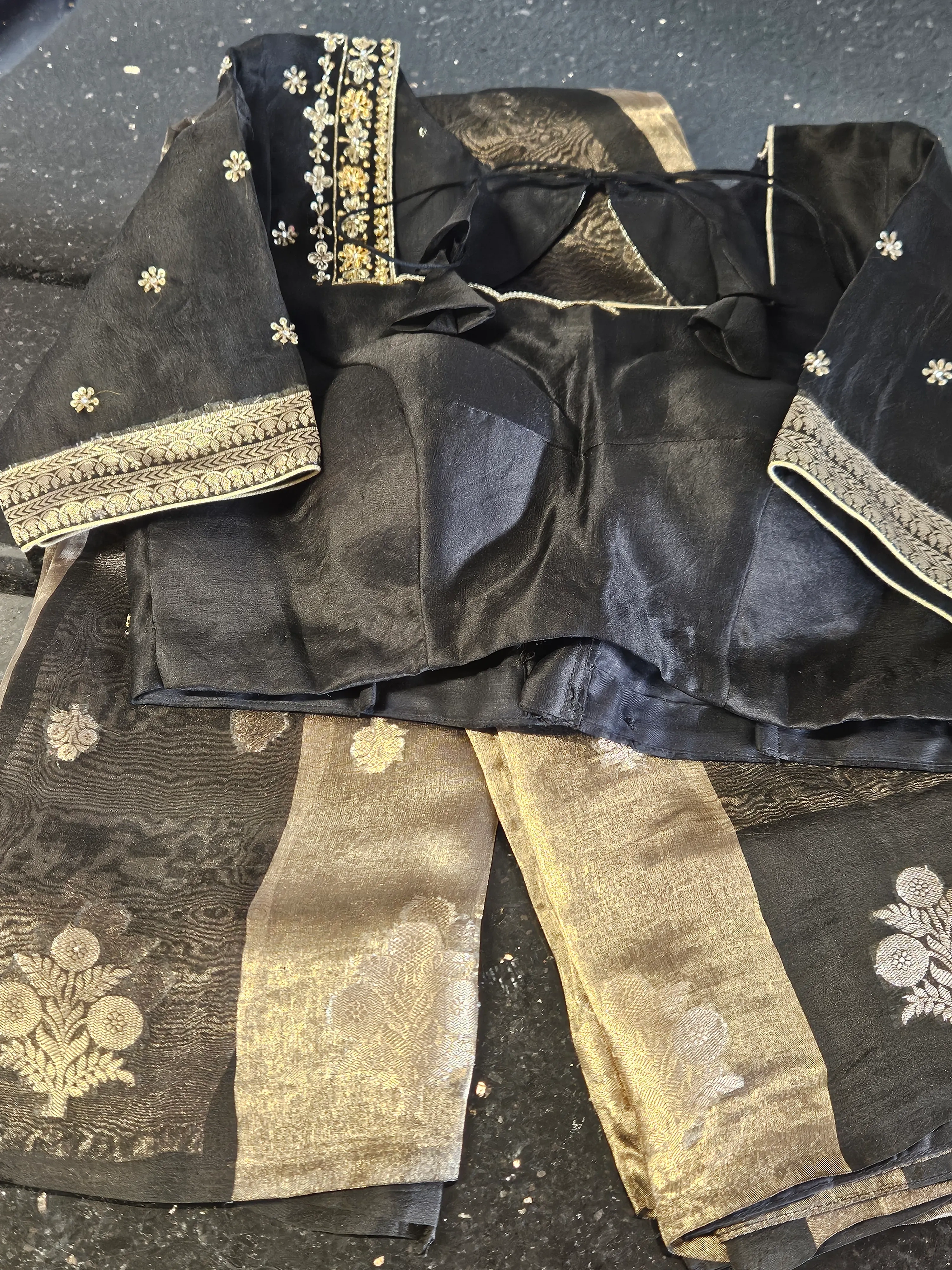 Pure Banarasi Kora tissue saree with gold and silver zari work, paired with a black embroidered blouse, elegant ethnic wear