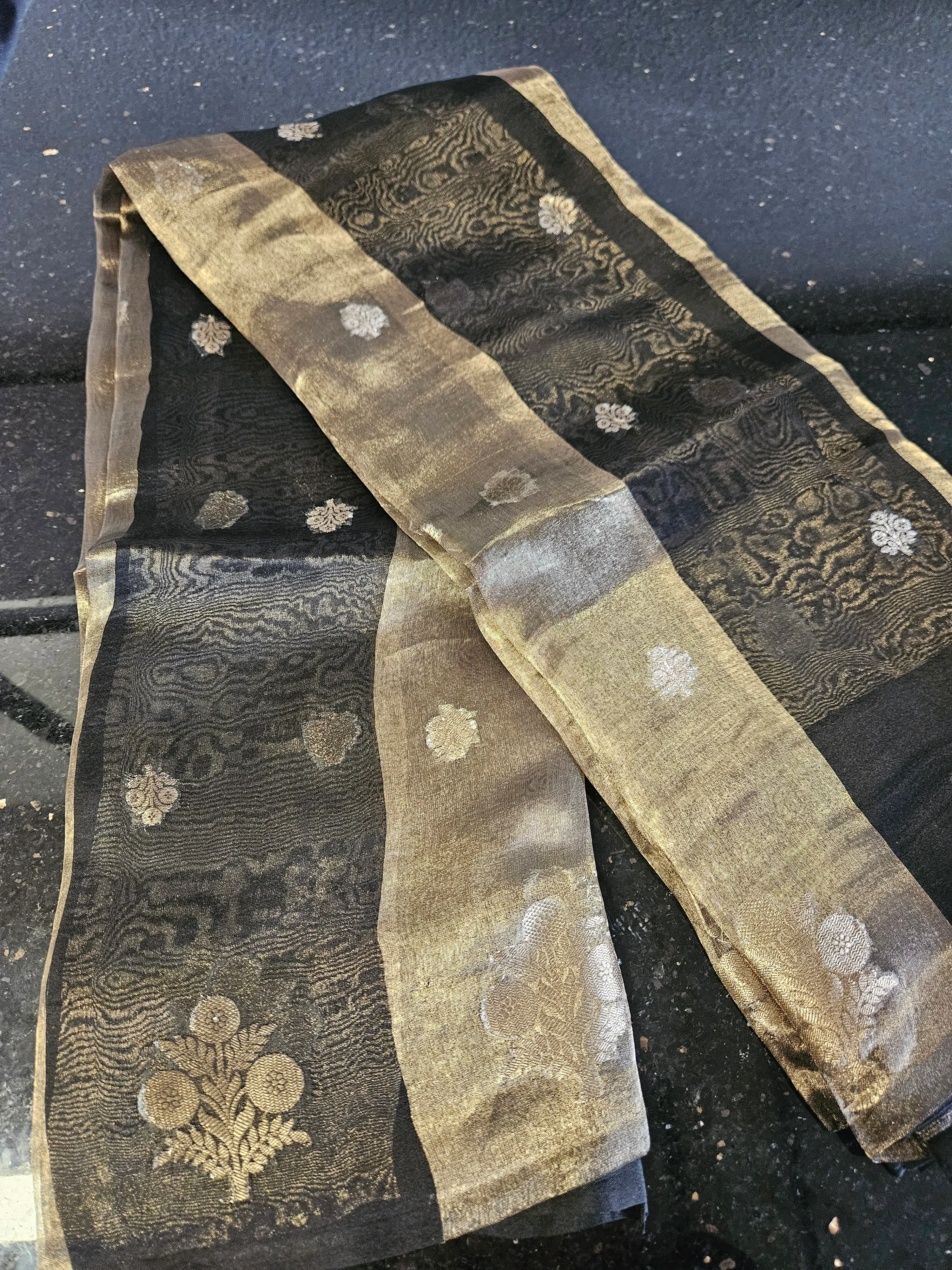 Pure Banarasi Kora tissue saree in black with gold and silver zari floral motifs and intricate woven borders, elegant ethnic wear