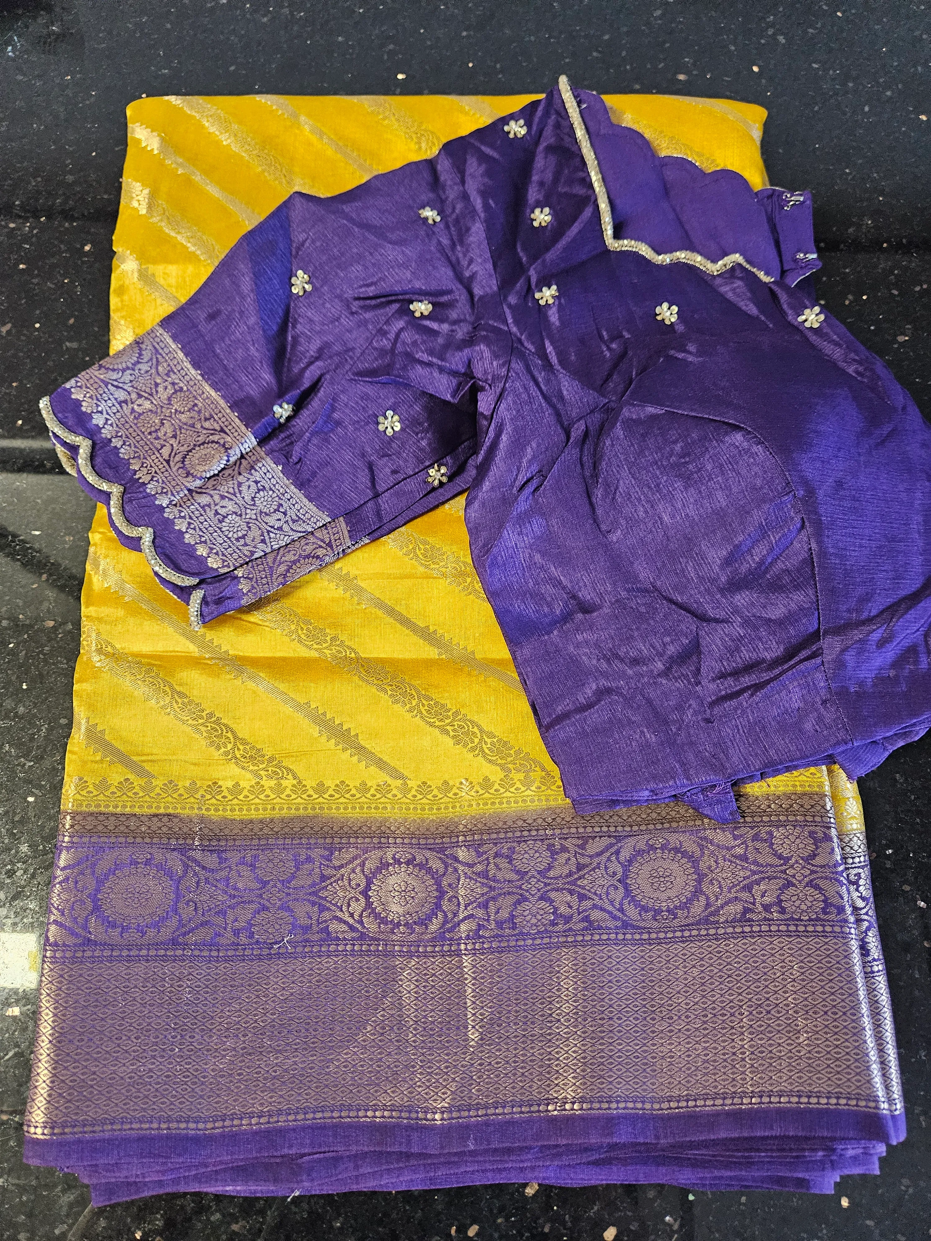 Handwoven pure raw mango silk saree in golden yellow with intricate gold zari border, paired with a purple embroidered blouse.