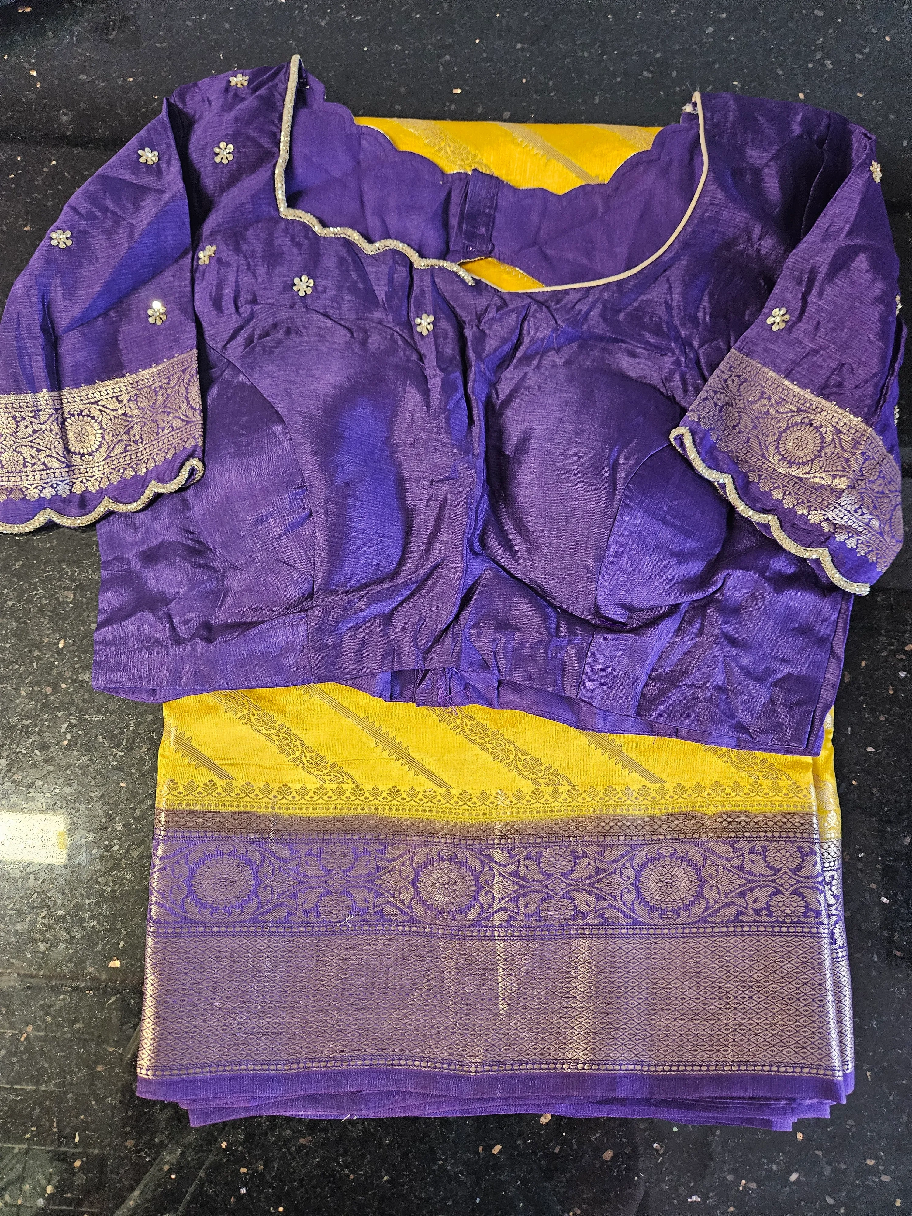 Handwoven pure raw mango silk saree in golden yellow with intricate silver zari border, paired with a purple blouse.