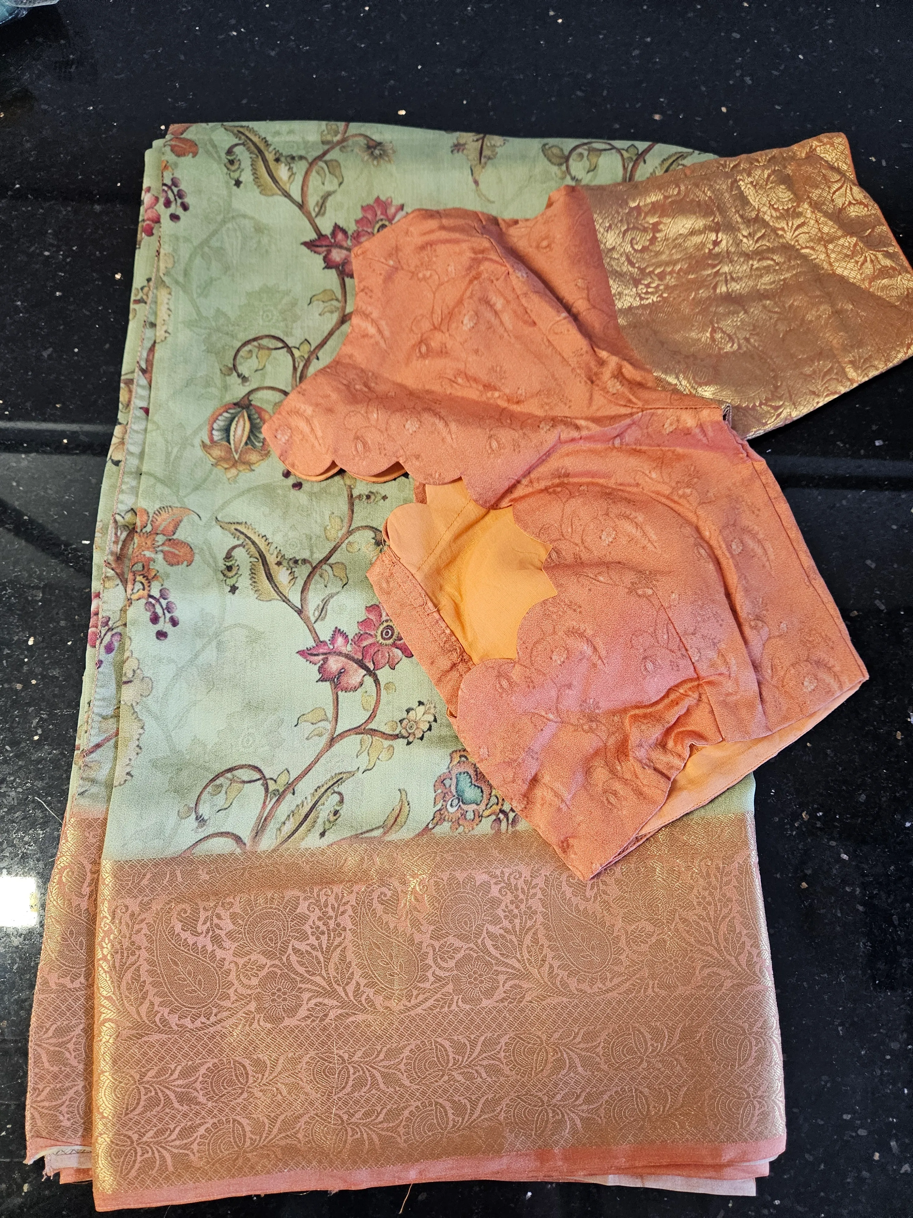 Pure Banarasi silk handwoven saree in pastel green with intricate floral motifs and gold zari border, paired with peach blouse fabric.