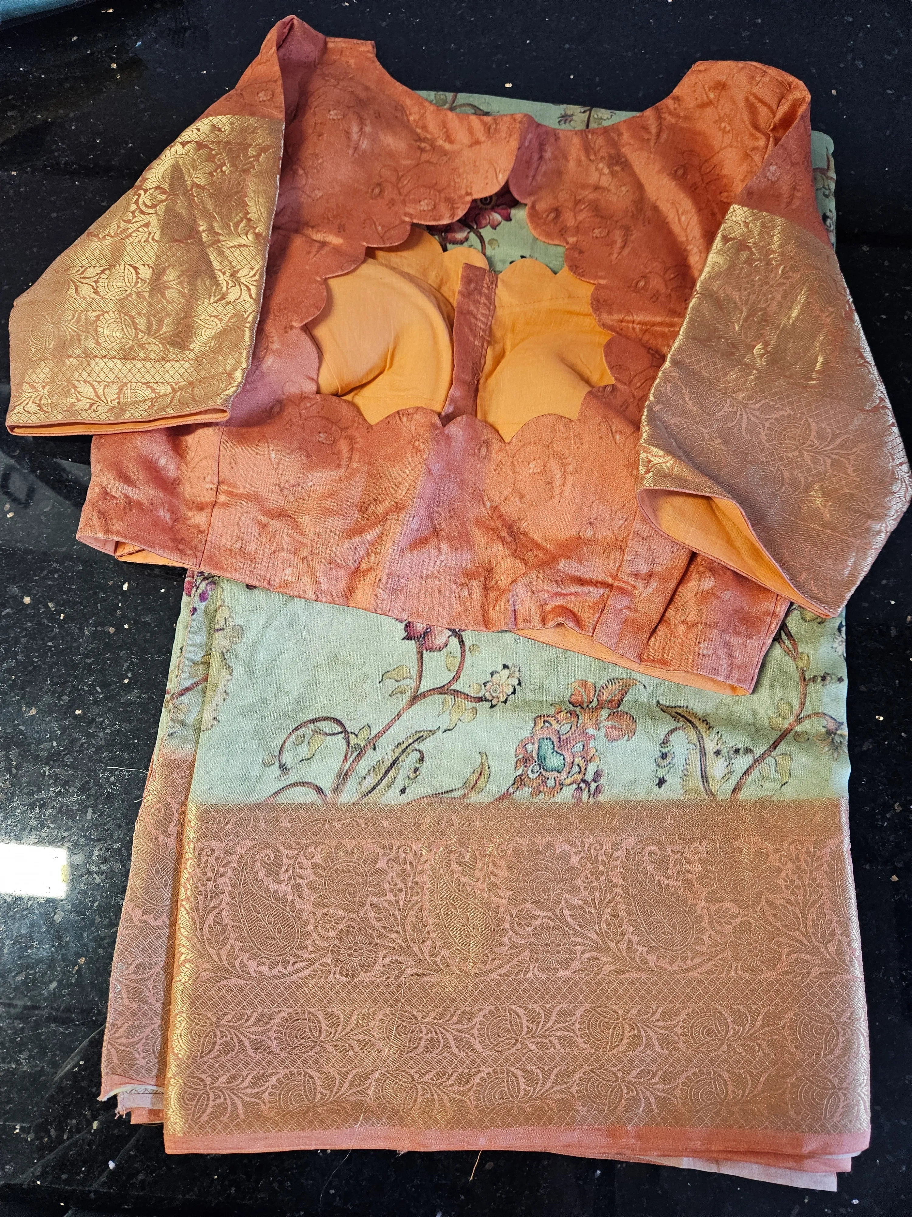 Pure Banarasi silk handwoven saree in pastel green with intricate floral motifs and peach zari border, paired with peach blouse.