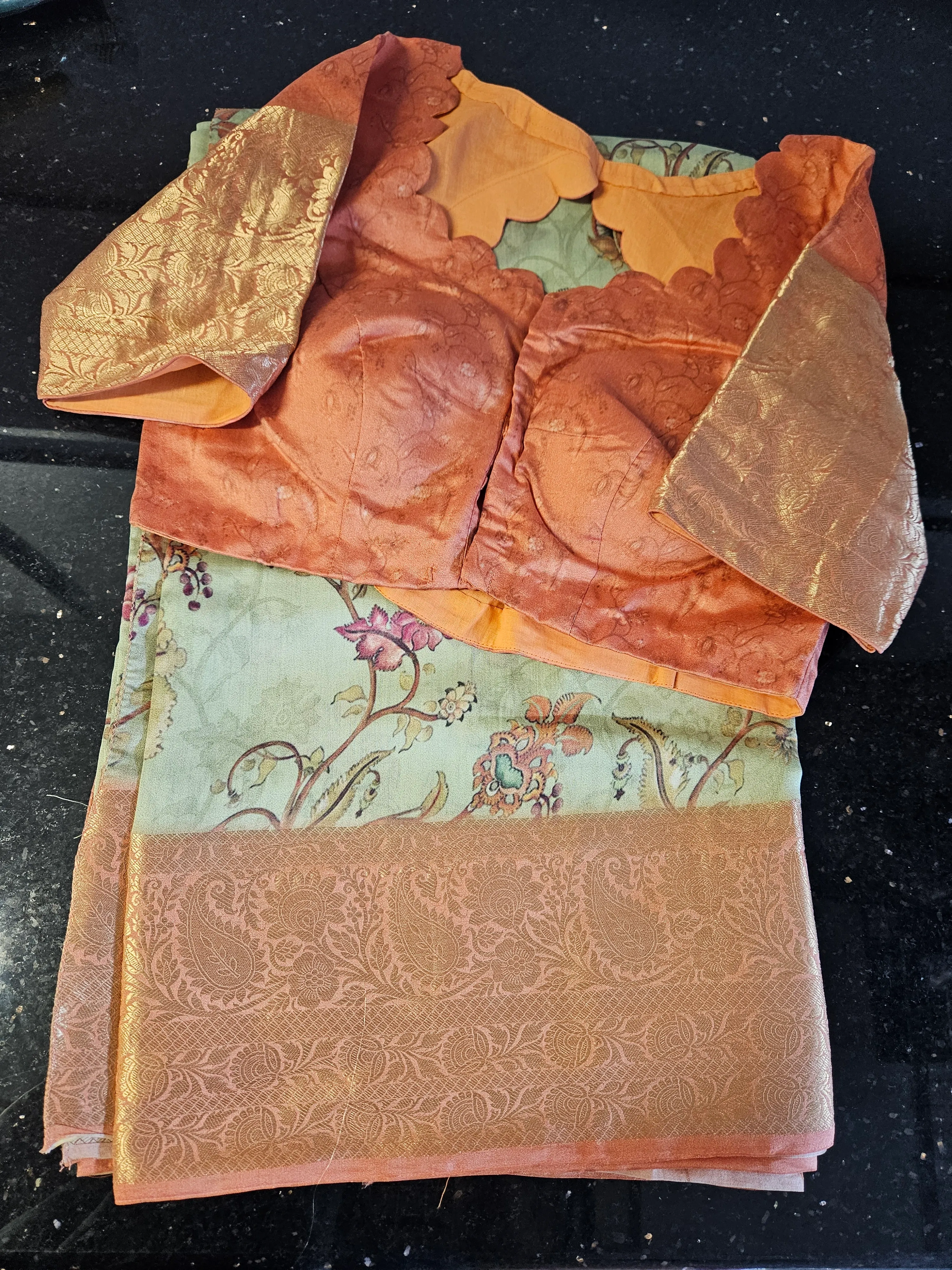 Pure Banarasi silk handwoven saree in mint green with gold floral motifs, paired with an ornate peach blouse and gold zari work.