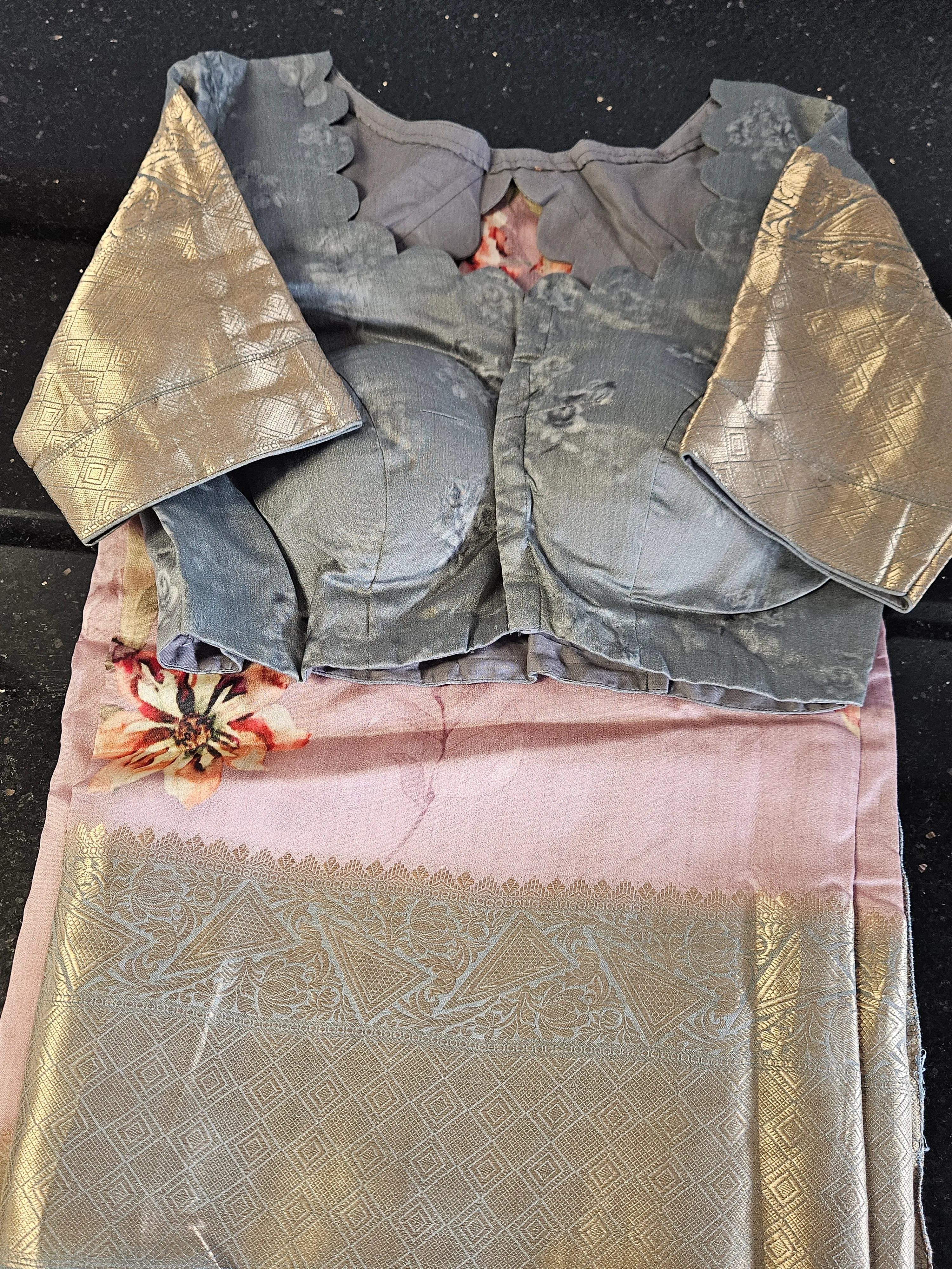 Handwoven Banarasi silk saree in soft pink with silver zari floral motifs, paired with a matching blouse featuring gold zari sleeves.
