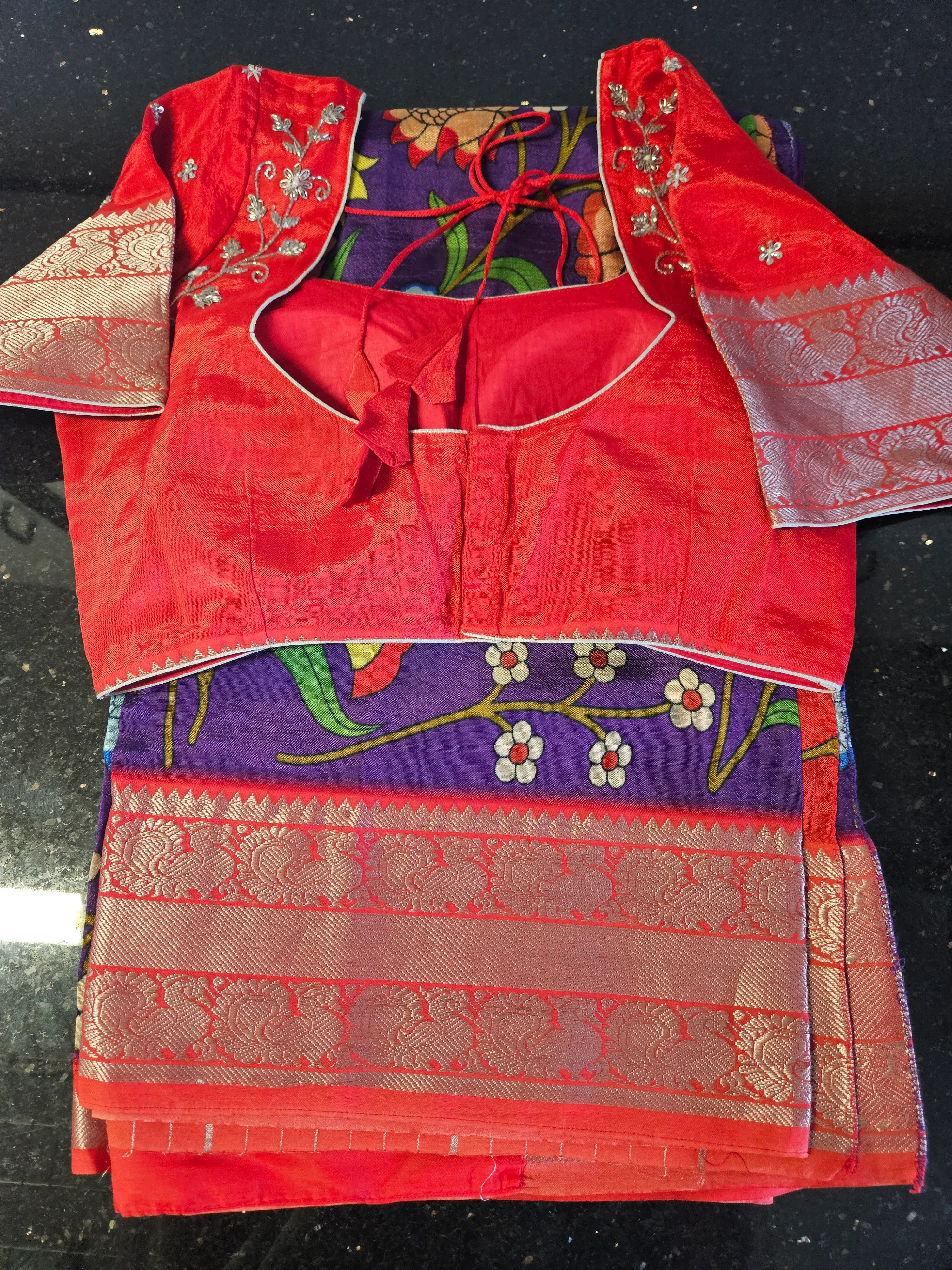 Handwoven Mangalagiri silk pattu saree with golden zari border, vibrant purple and red colors, floral patterns, and matching blouse.