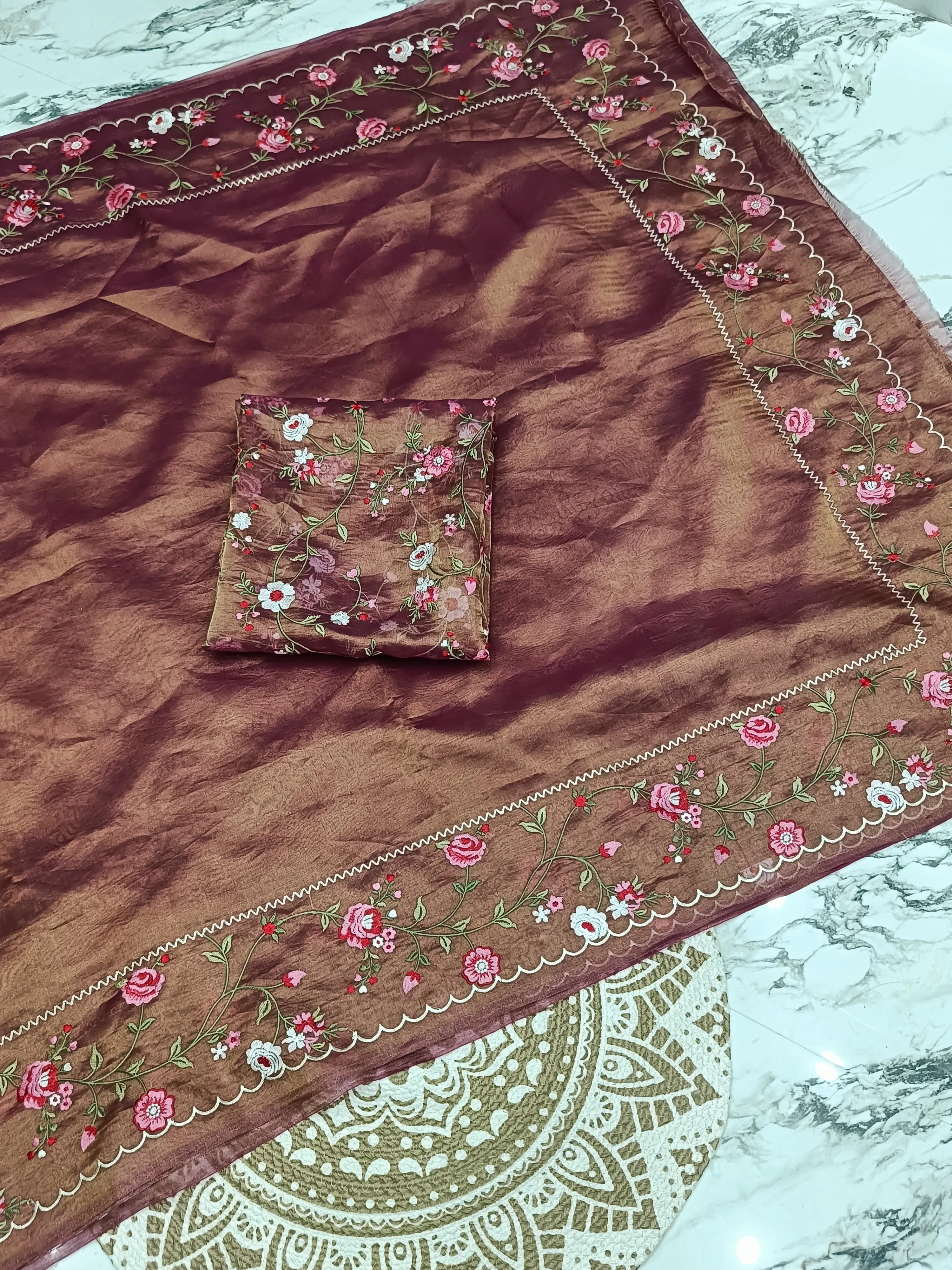 Golden handwoven Banarasi tissue saree with pure zari work, featuring floral embroidery and scalloped border, ideal for weddings.