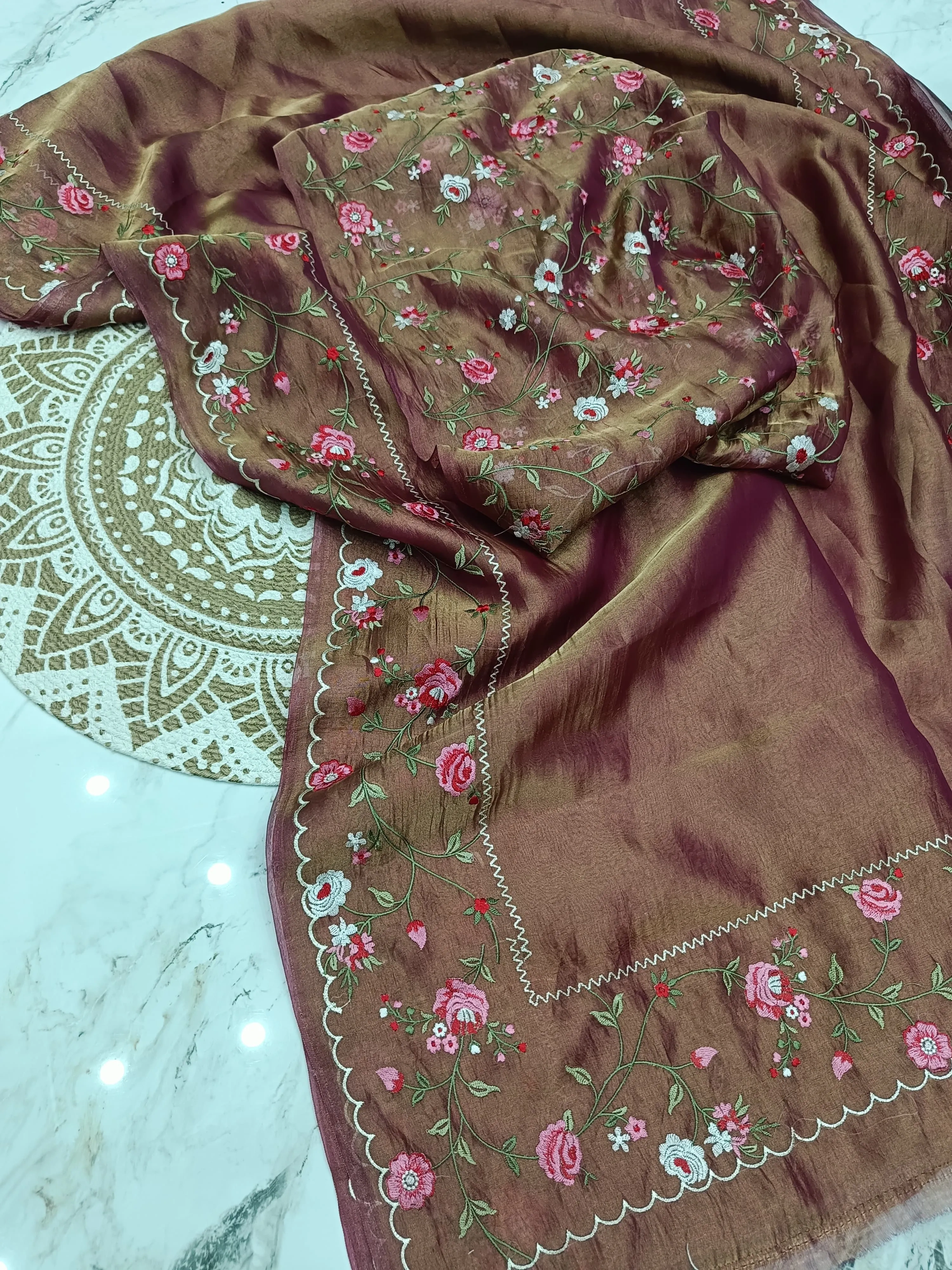 Golden handwoven Banarasi tissue saree with pure zari work, featuring pink floral embroidery, ideal for weddings and festivals