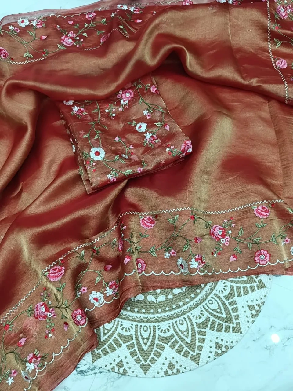Pure Banarasi tissue saree in gold zari with intricate floral embroidery and scalloped border, perfect for weddings.