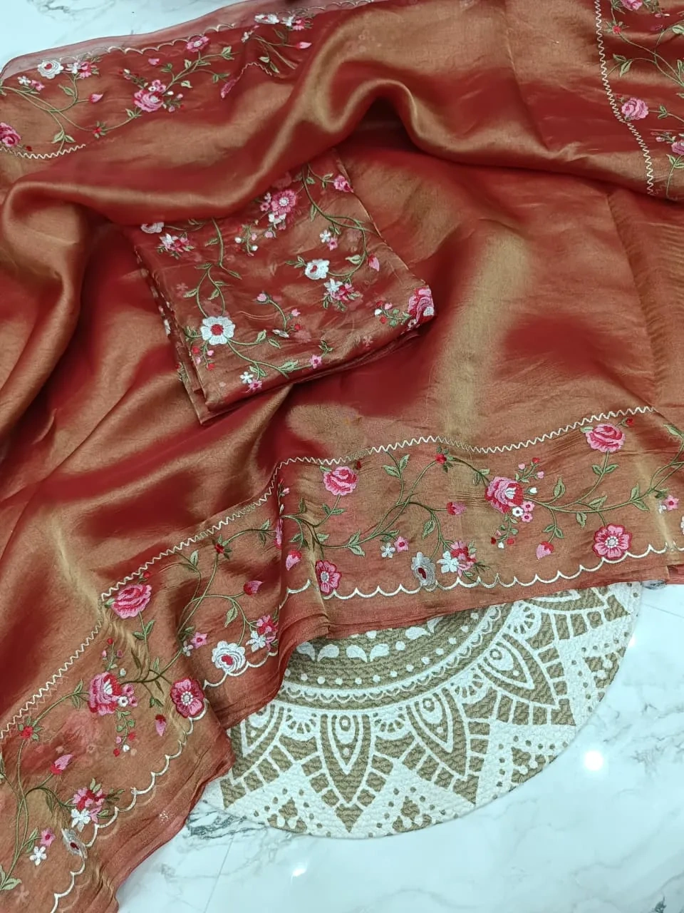Pure Banarasi tissue saree in gold zari with delicate pink and white floral embroidery, perfect for weddings and celebrations