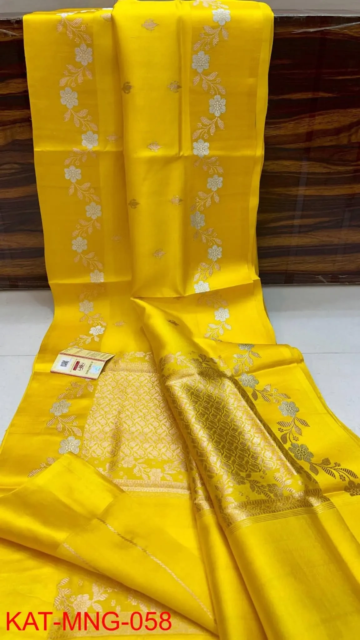 Handwoven pure pattu silk saree in raw mango yellow with intricate gold zari floral motifs, perfect for weddings.