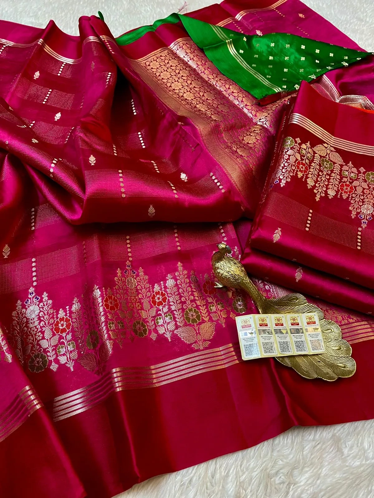 Pure handloom raw mango yellow silk pattu saree with rich magenta body, gold zari floral motifs, and contrasting green blouse.