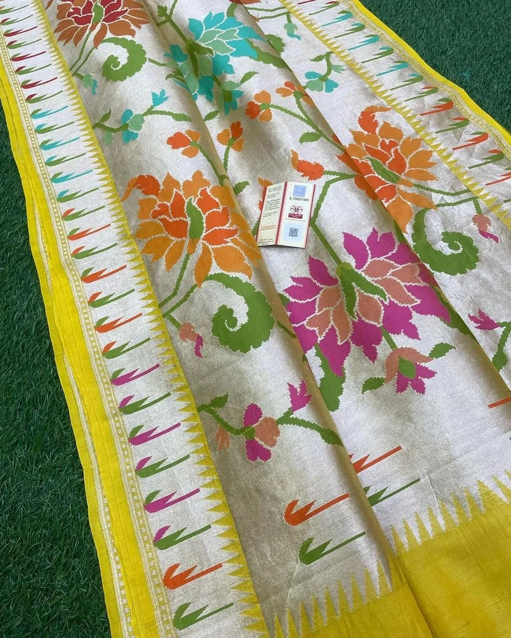 Pure Tussar silk georgette saree in beige with vibrant floral motifs and a yellow border, ideal for weddings and festivals.