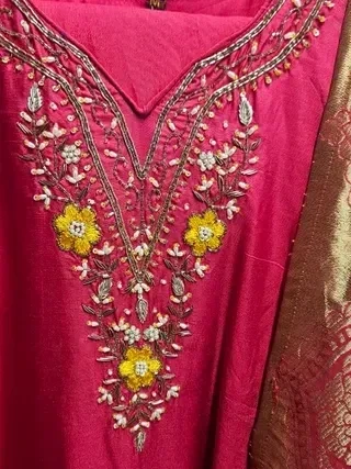 Pure Dola silk maroon Indian dress with intricate golden embroidery, floral patterns, and delicate bead embellishments.