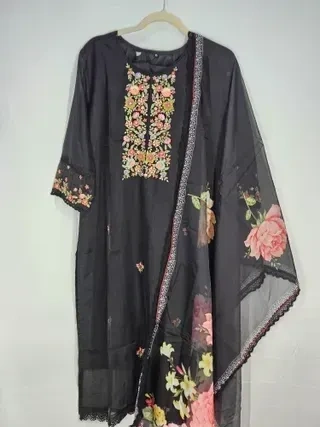 Handcrafted pure muslin lehenga in earthy black tones with floral embroidery and sheer dupatta, ideal for weddings and festive wear