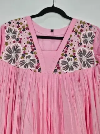 Blush pink mul cotton midi dress featuring handcrafted charcoal grey floral embroidery on the yoke and pleated detailing.