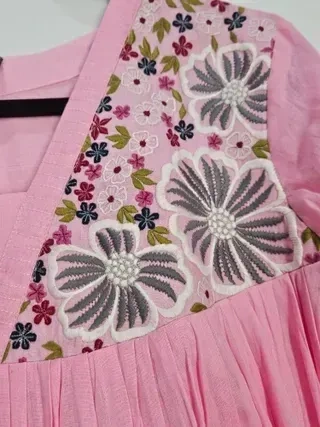 Blush pink mul cotton midi dress featuring handcrafted charcoal grey and white floral embroidery with multicolor accents.