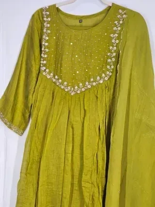 Hand-embroidered mul Chanderi silk beige suit with sequin and floral detailing, perfect for weddings and festive occasions