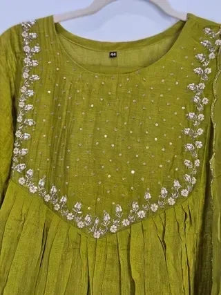 Hand-embroidered mul Chanderi silk suit in olive green with delicate floral embroidery and sequin detailing on the yoke.