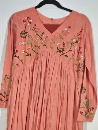 Pastel pink mul cotton kurta set with delicate floral embroidery, V-neckline, and gathered detailing, perfect for festive wear